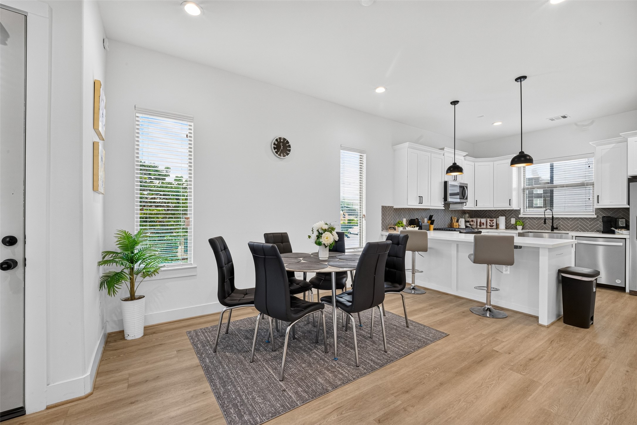 Tall vertical windows frame the dedicated dining space, creating an airy, sunlit nook ideal for morning coffee and every meal.