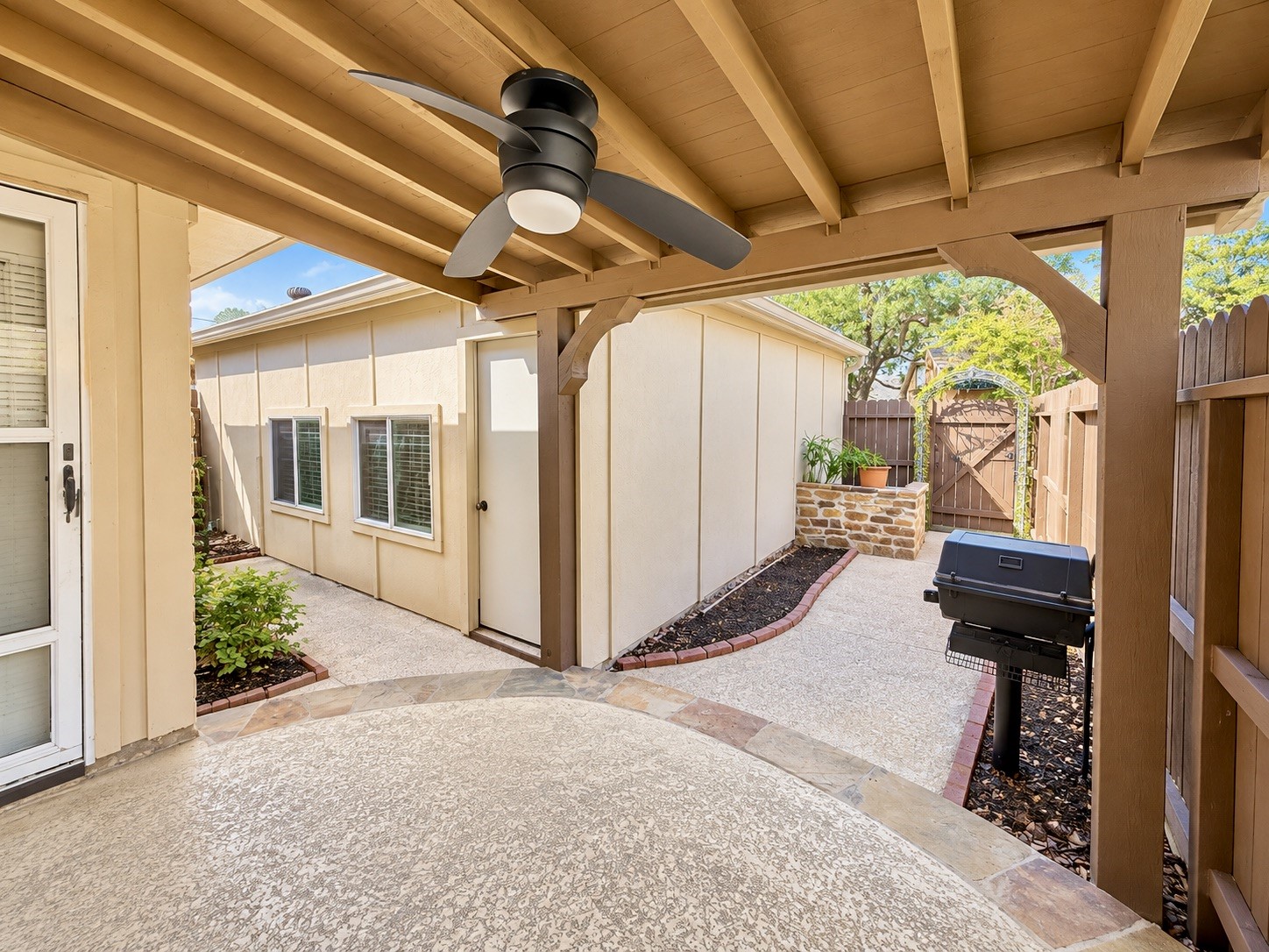 View of the super useful fully fenced in backyard with a great sized 2 car detached garage.