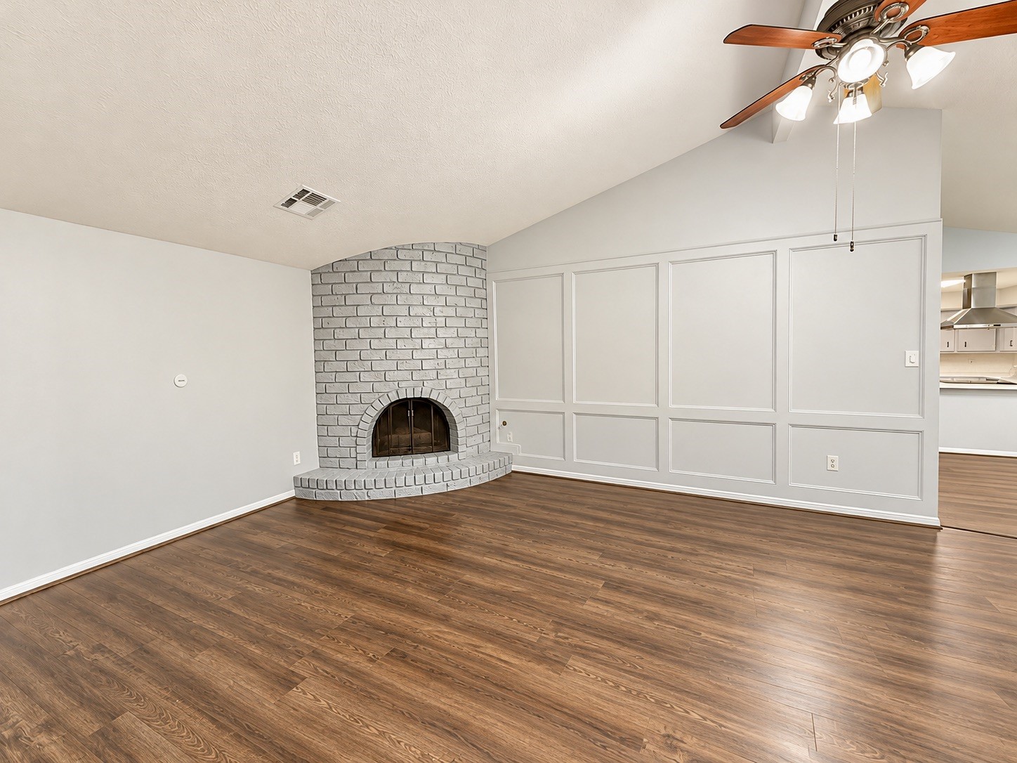 Living Room features a handsome corner fireplace, and detailed wall trim decor.