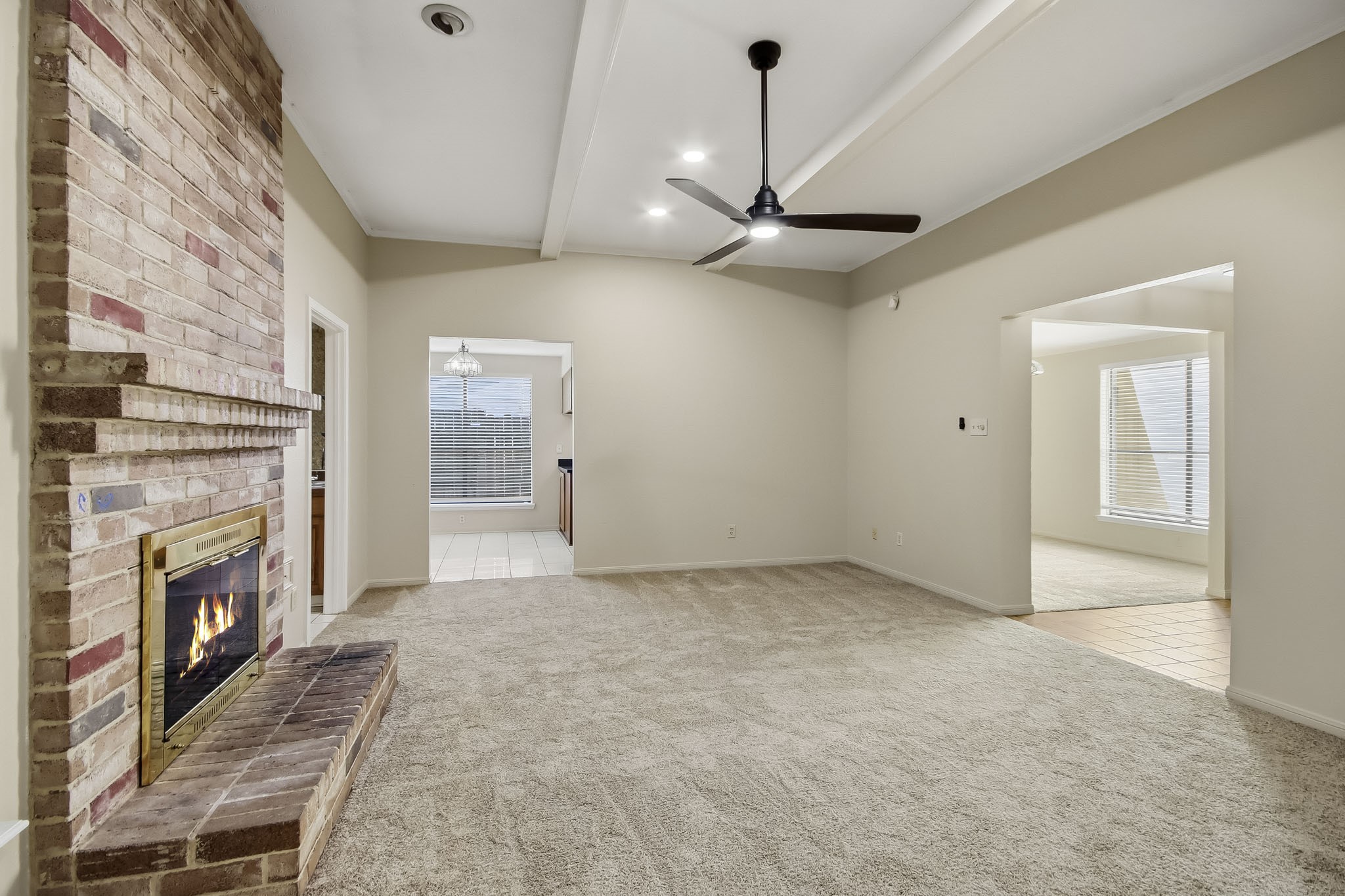 Another view of the spacious living room, with easy access to the kitchen and adjoining flex space.