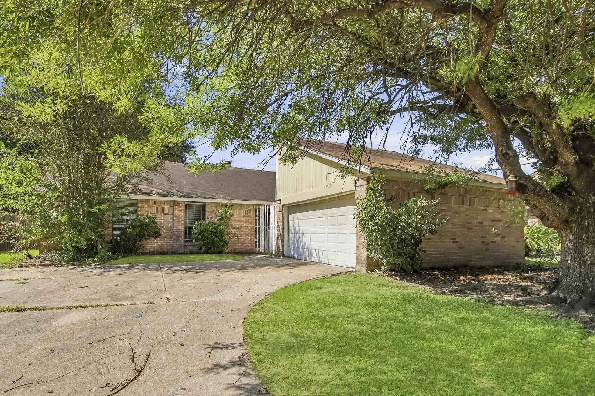Welcome to 8807 Lakeside Forest Drive! Featuring a brick exterior, mature trees, a two-car garage, and a gated entrance leading to the patio and front door. Welcome to 8807 Lakeside Forest Drive! Featuring a brick exterior, mature trees, a two-car garage, and a gated entrance leading to the patio and front door.