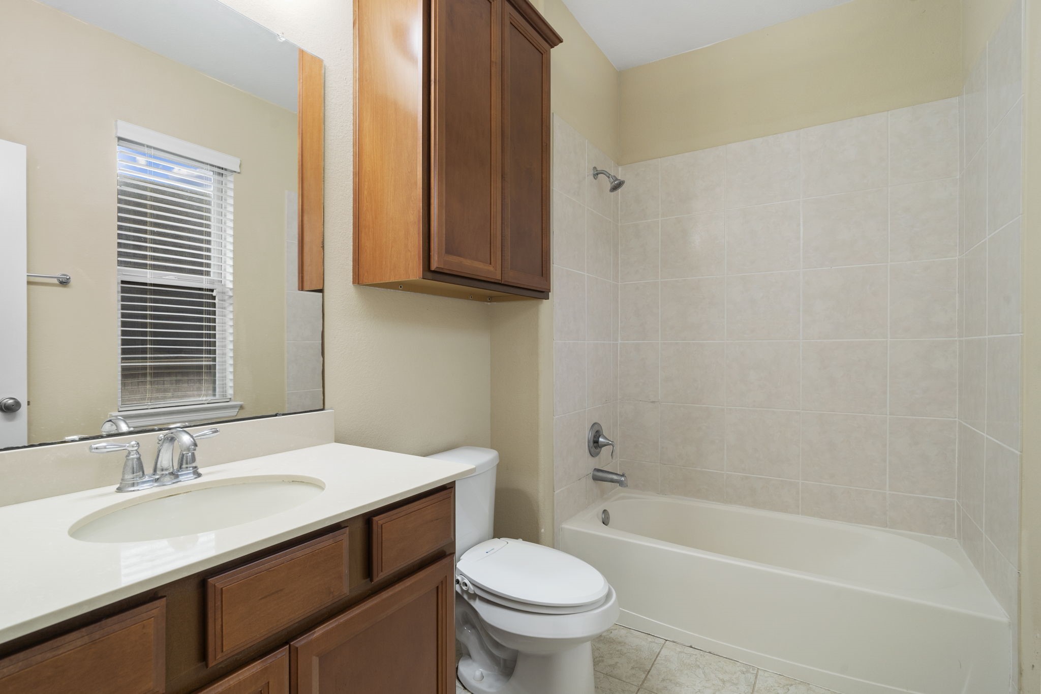 En-suite full bathroom with a shower/tub combination and a spacious vanity.