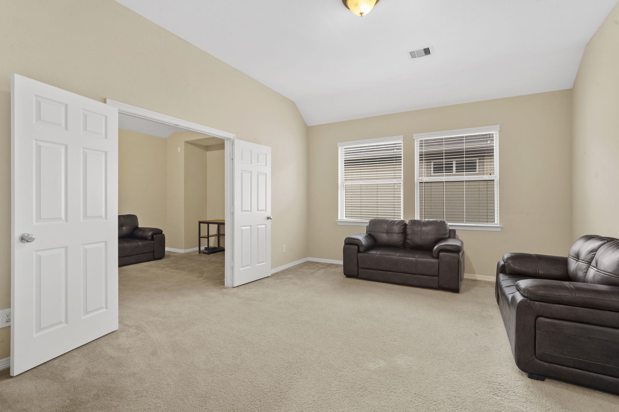 Second-floor game room featuring double doors that open to a separate media room.