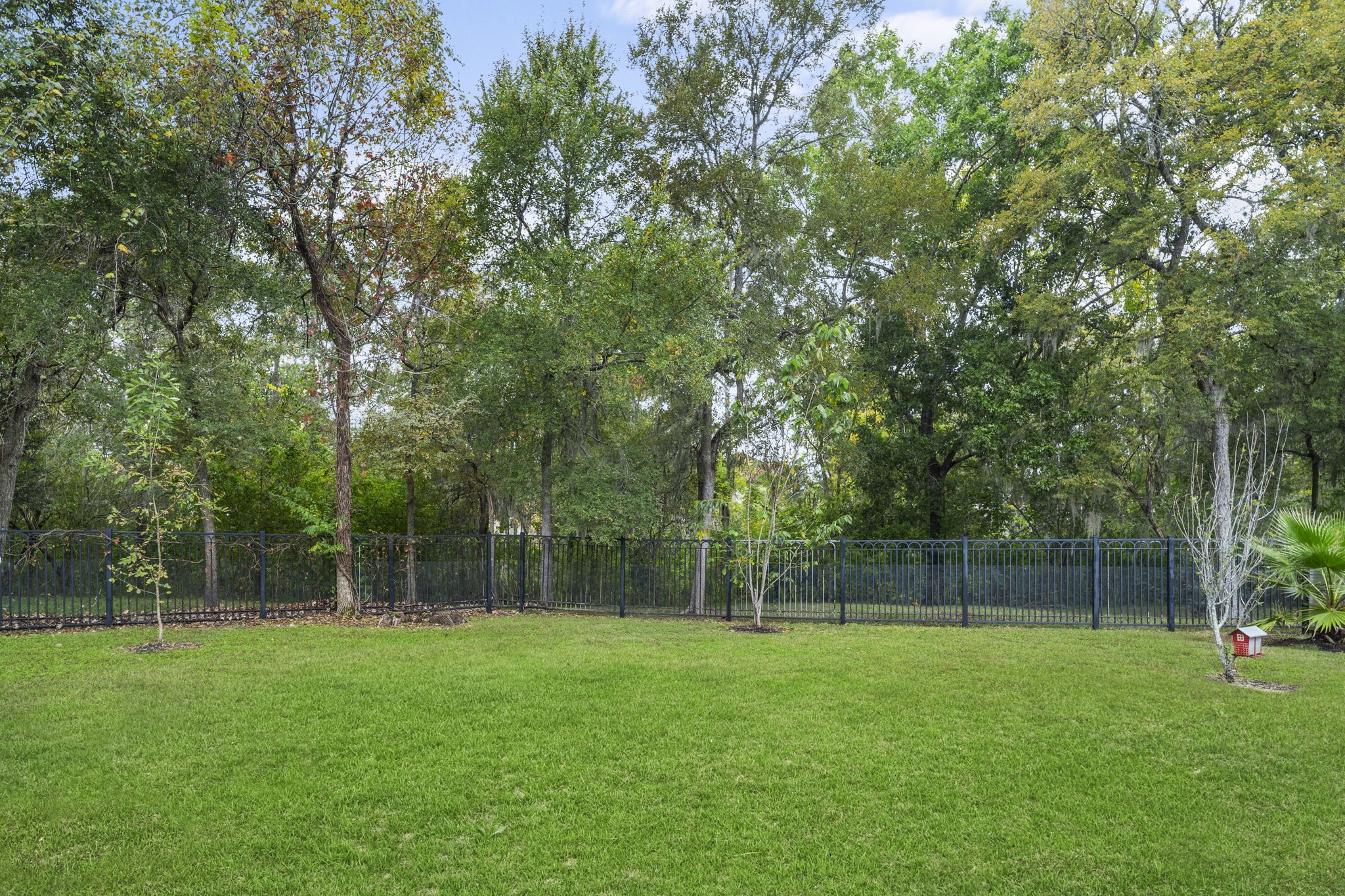 Situated on an expansive 12,949-square-foot lot with no rear neighbors and a greenway backdrop.