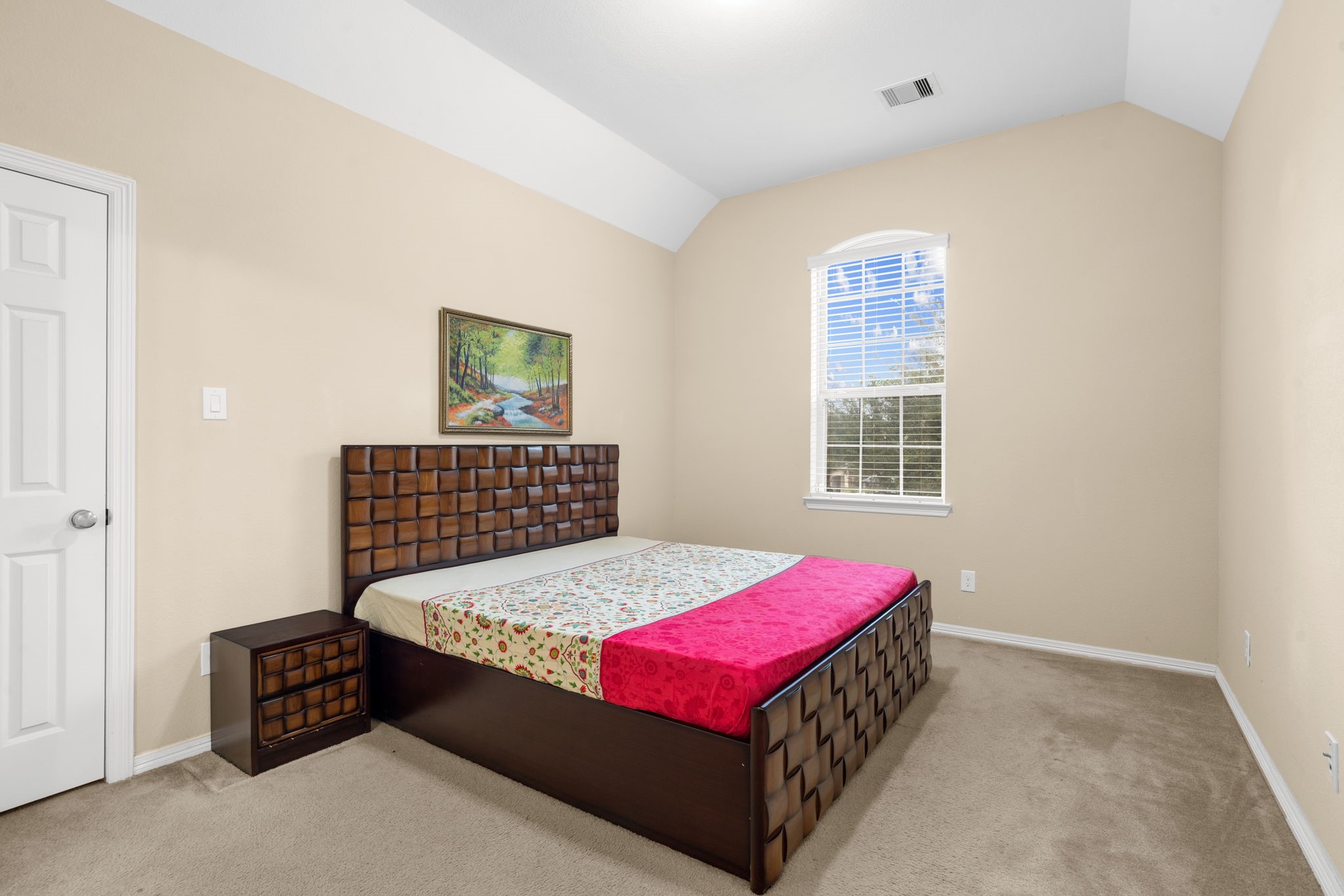 This bedroom features a high ceiling, walk-in closet, and Hollywood-style en-suite bathroom with shared access.