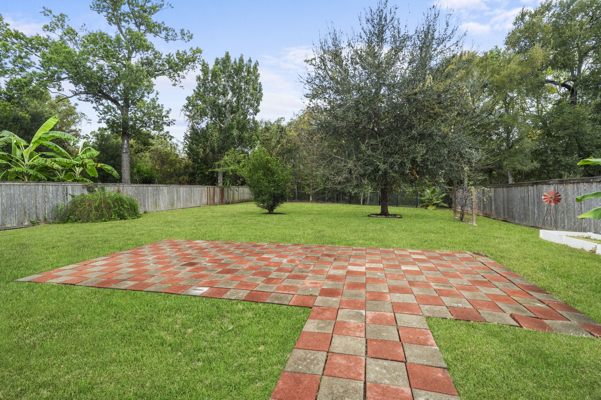 Fully fenced backyard with paved areas offering space to create inviting outdoor living and entertaining areas.