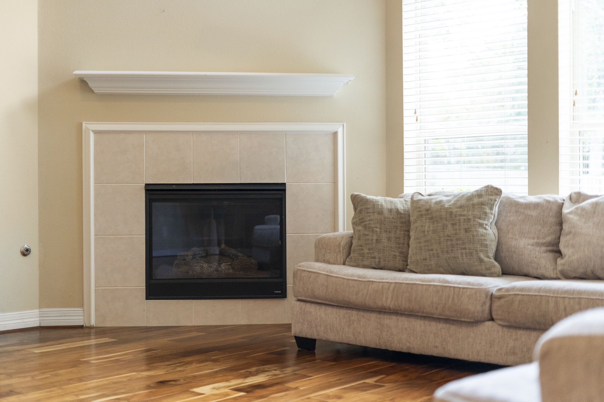A sophisticated gas-log fireplace creates an inviting focal point for entertaining and holiday gatherings.