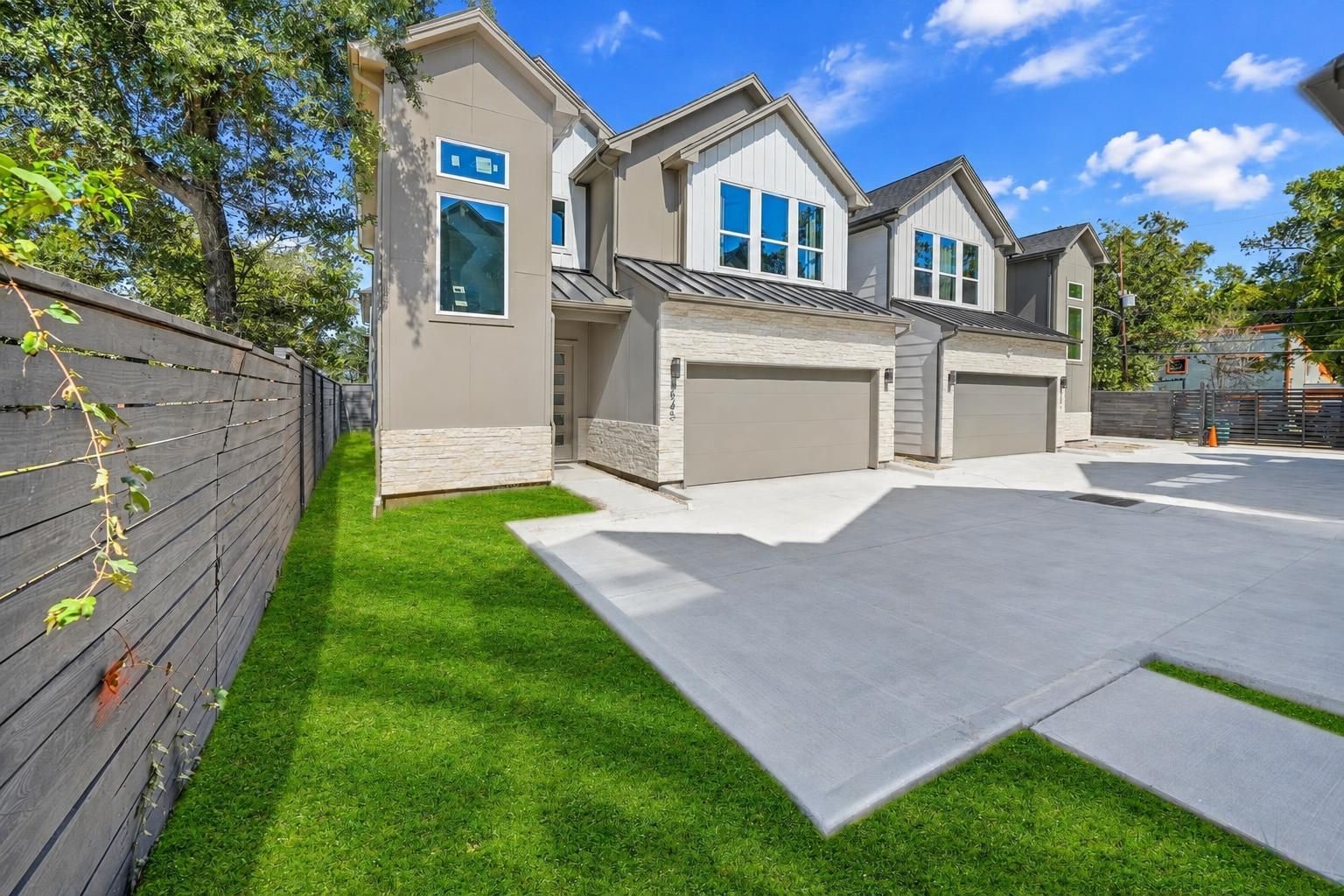 The exterior of the home showing the greenery and driveway.
