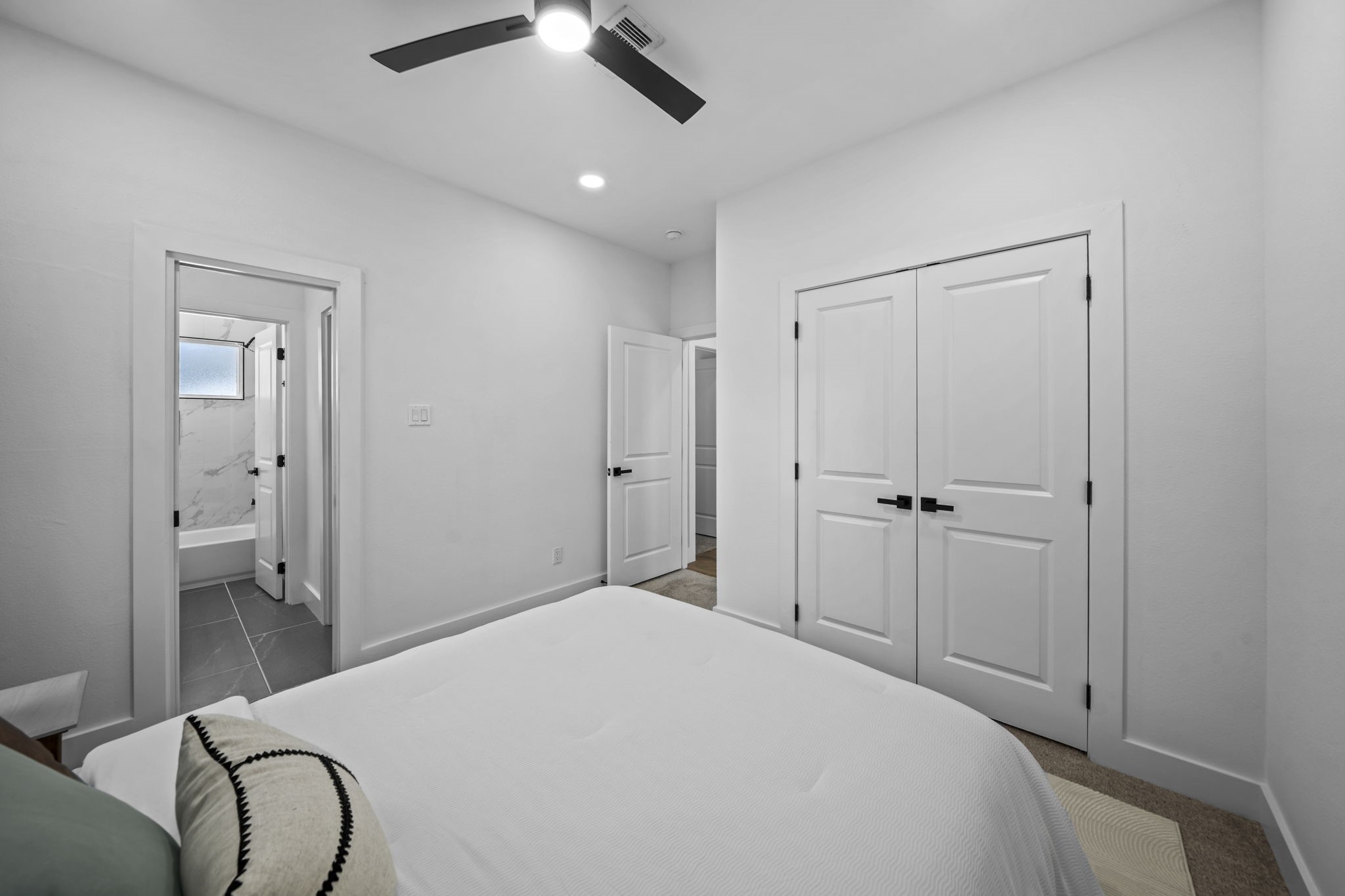 Another angle of the second bedroom showing the closet and entrance to the shared secondary bathroom.