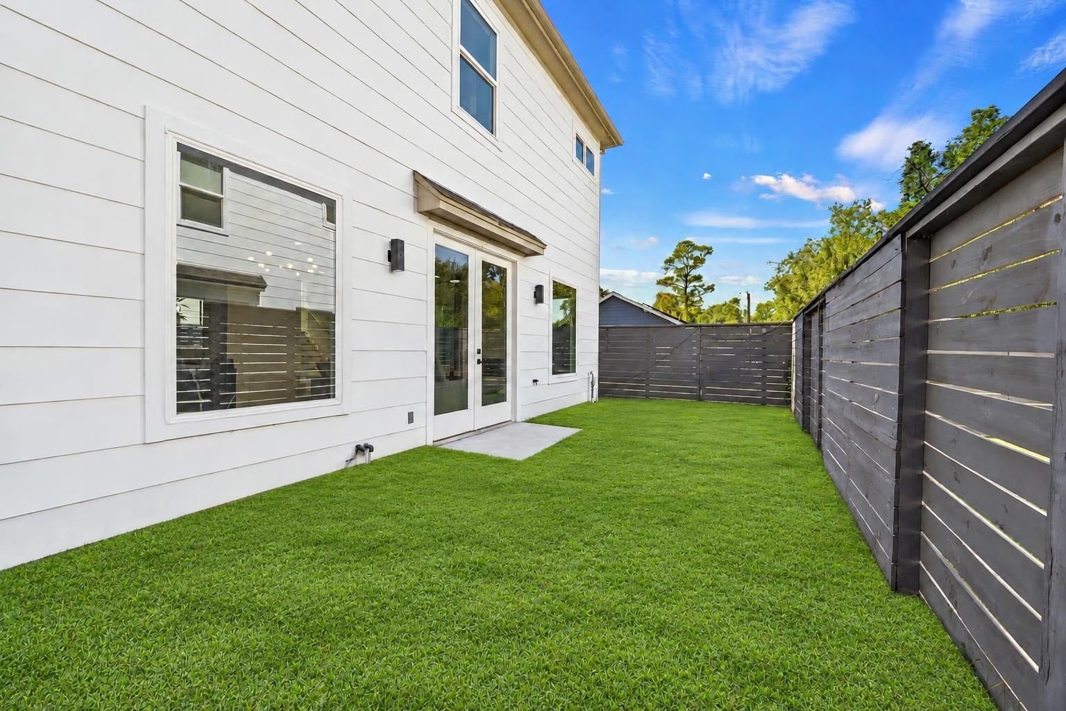 The home has a small patio and green space.