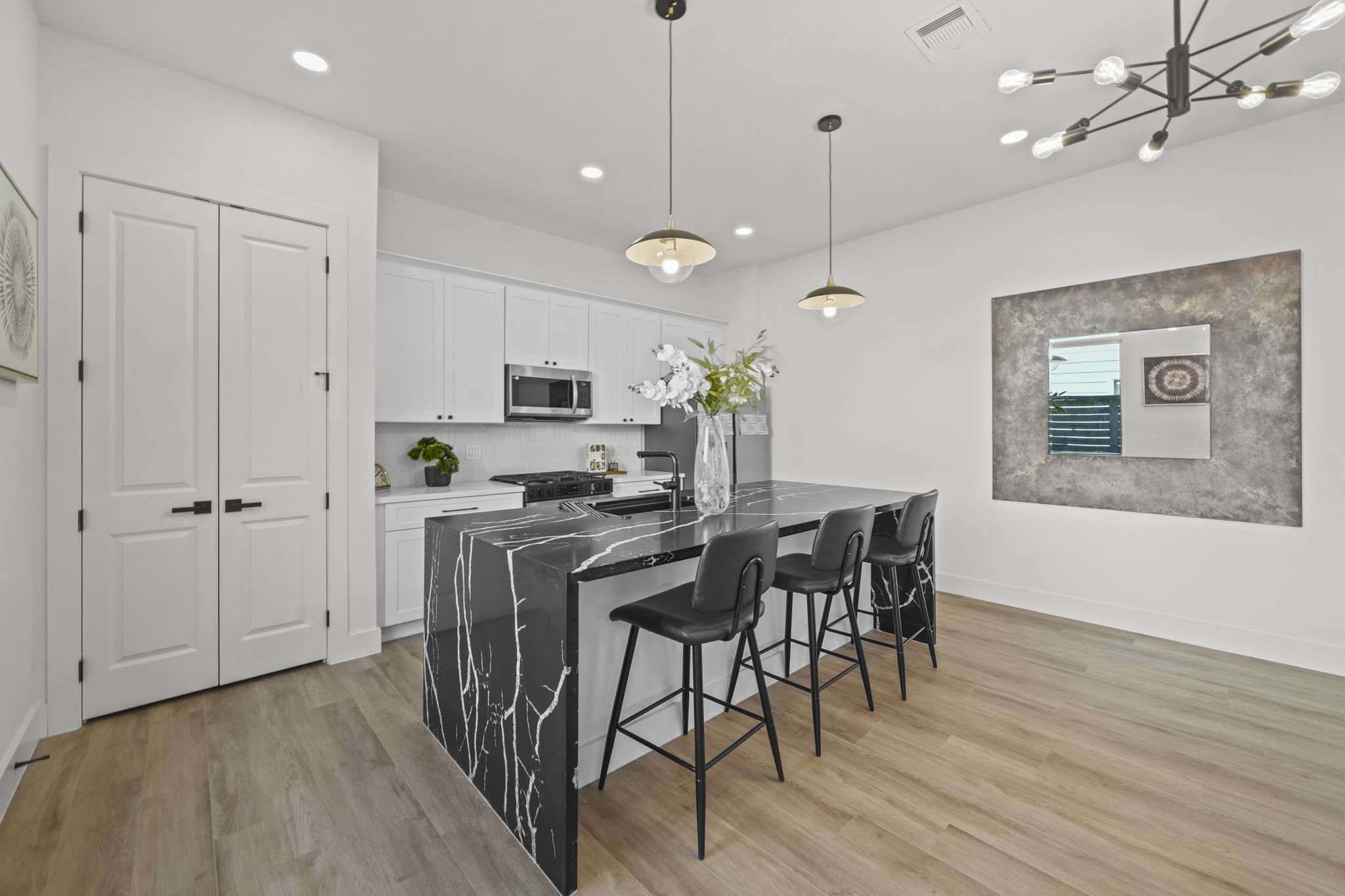 The kitchen centers on the elegant island and breakfast bar with a full size pantry.