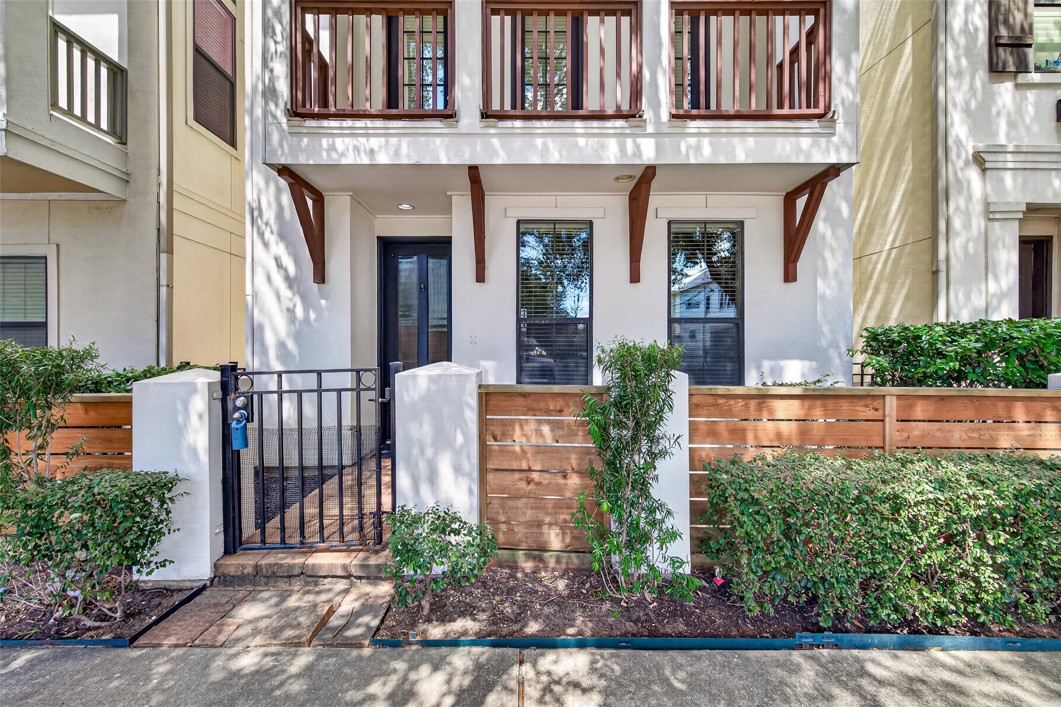 Charming townhouse with a welcoming gated entrance, elegant balcony, and lush landscaping for added privacy. Charming townhouse with a welcoming gated entrance, elegant balcony, and lush landscaping for added privacy.