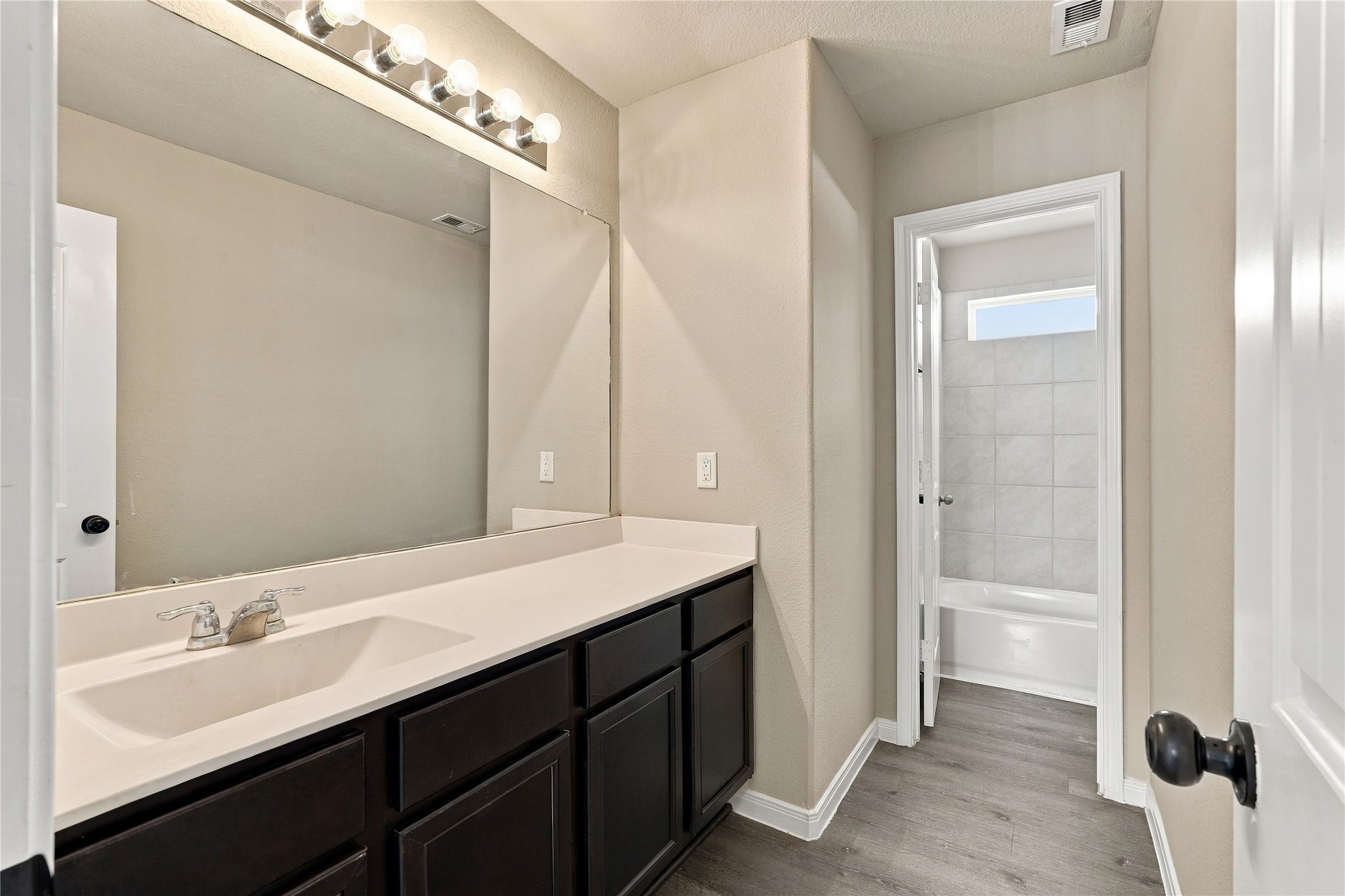 Hall Bathroom with vanity space & privacy room for tub/shower/toilet.