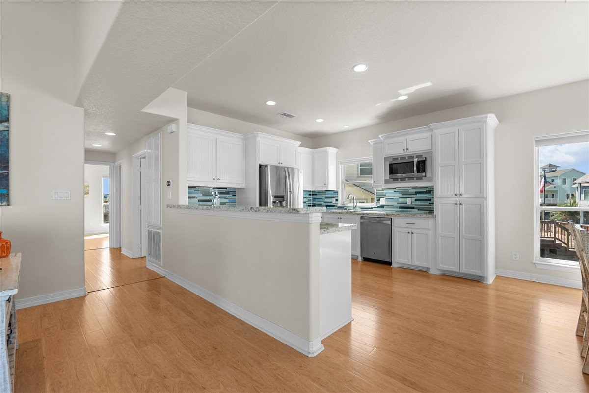 he kitchen impresses with designer backsplash, abundant cabinetry, stainless steel appliances, breakfast bar, and expansive granite countertops. he kitchen impresses with designer backsplash, abundant cabinetry, stainless steel appliances, breakfast bar, and expansive granite countertops.