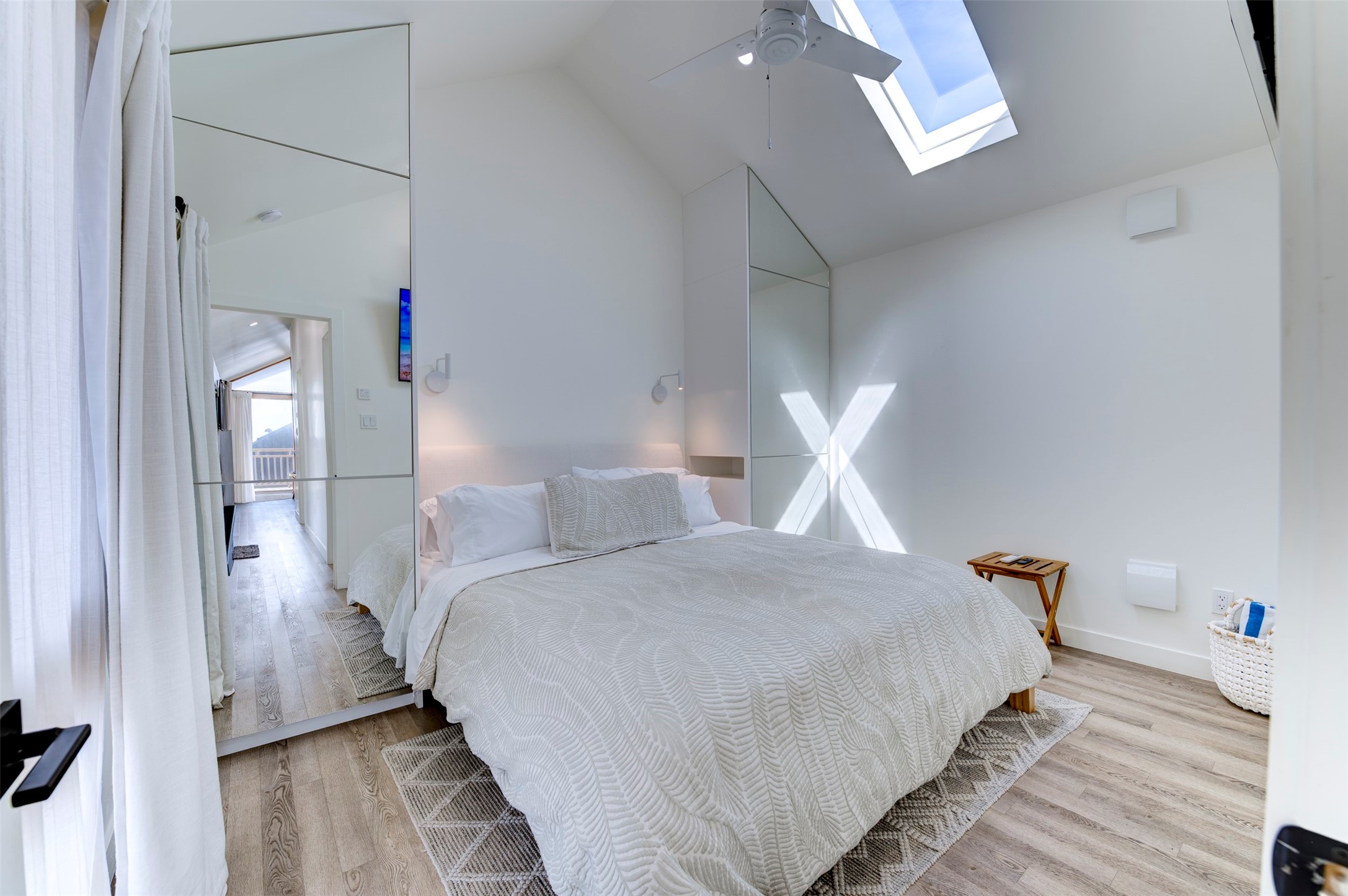 Back house primary king bedroom with built-in wardrobes and skylight