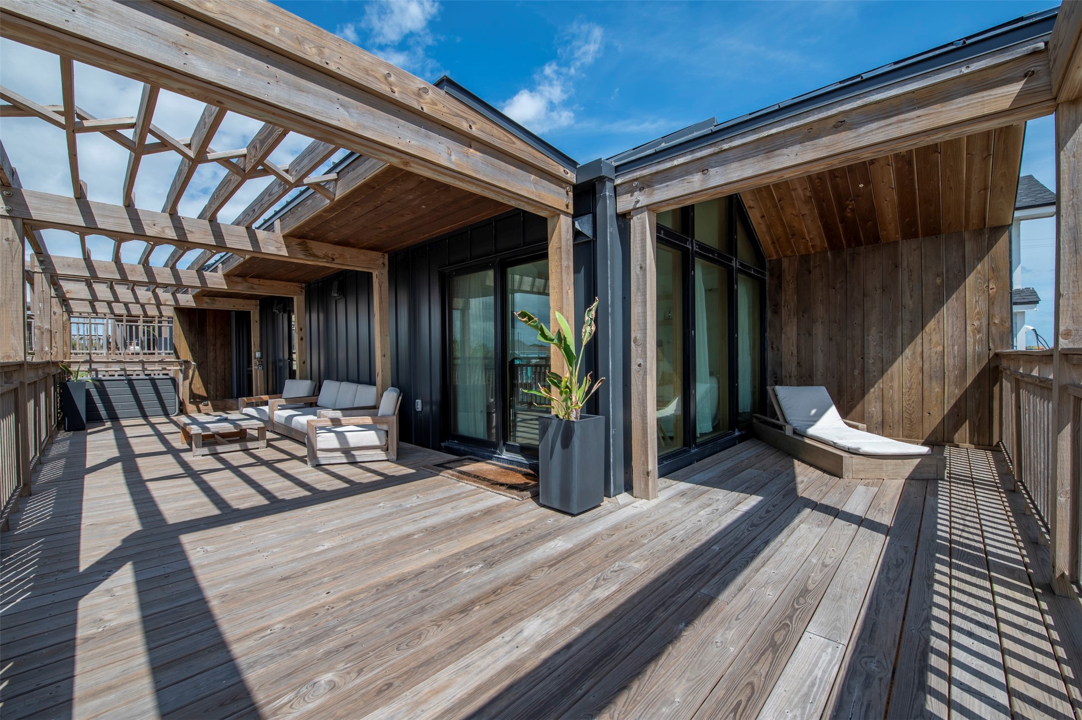 Front house wrap around deck with pergolas and seating