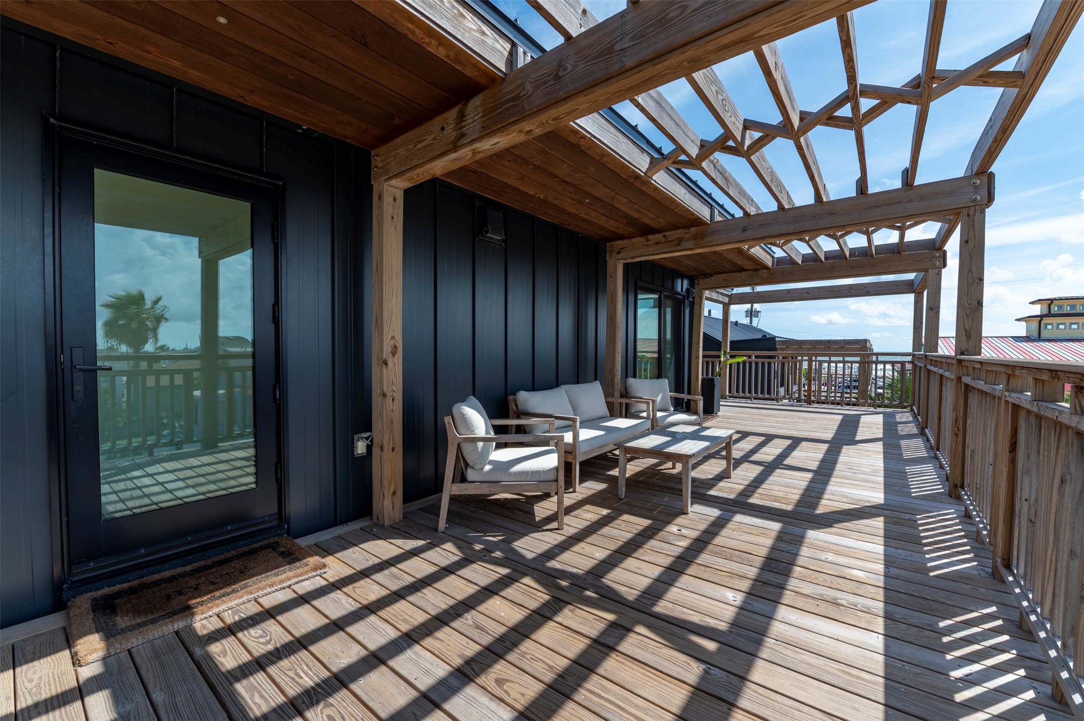 Back house upstairs deck with pergolas with and seating