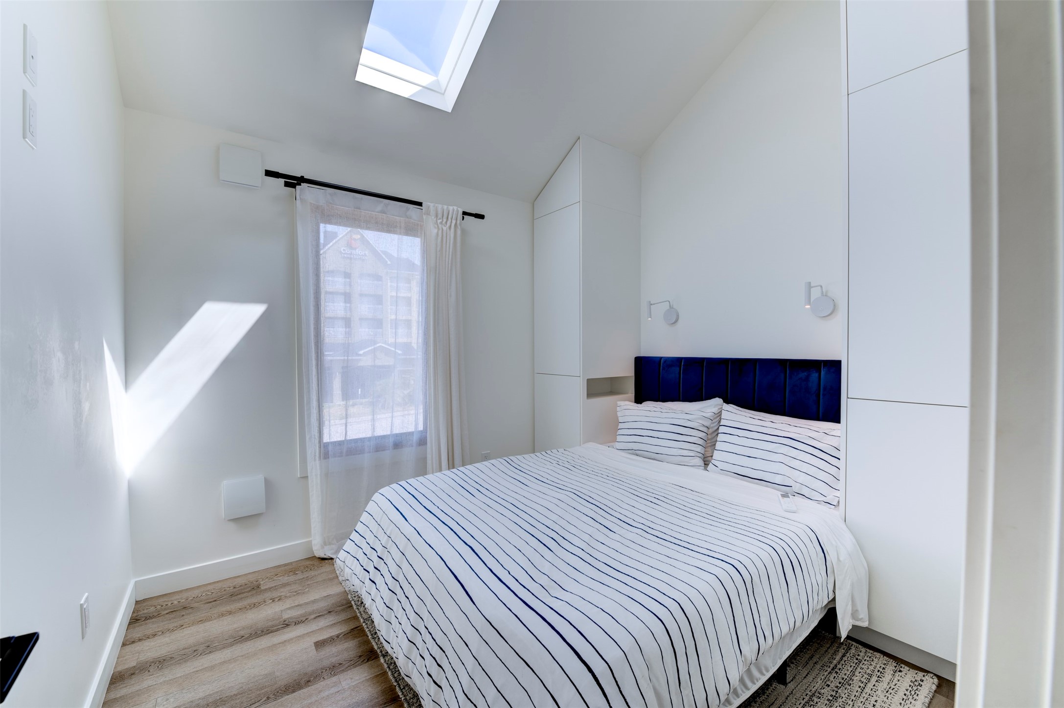 Back house Queen guest bedroom with built-in wardrobes and skylight