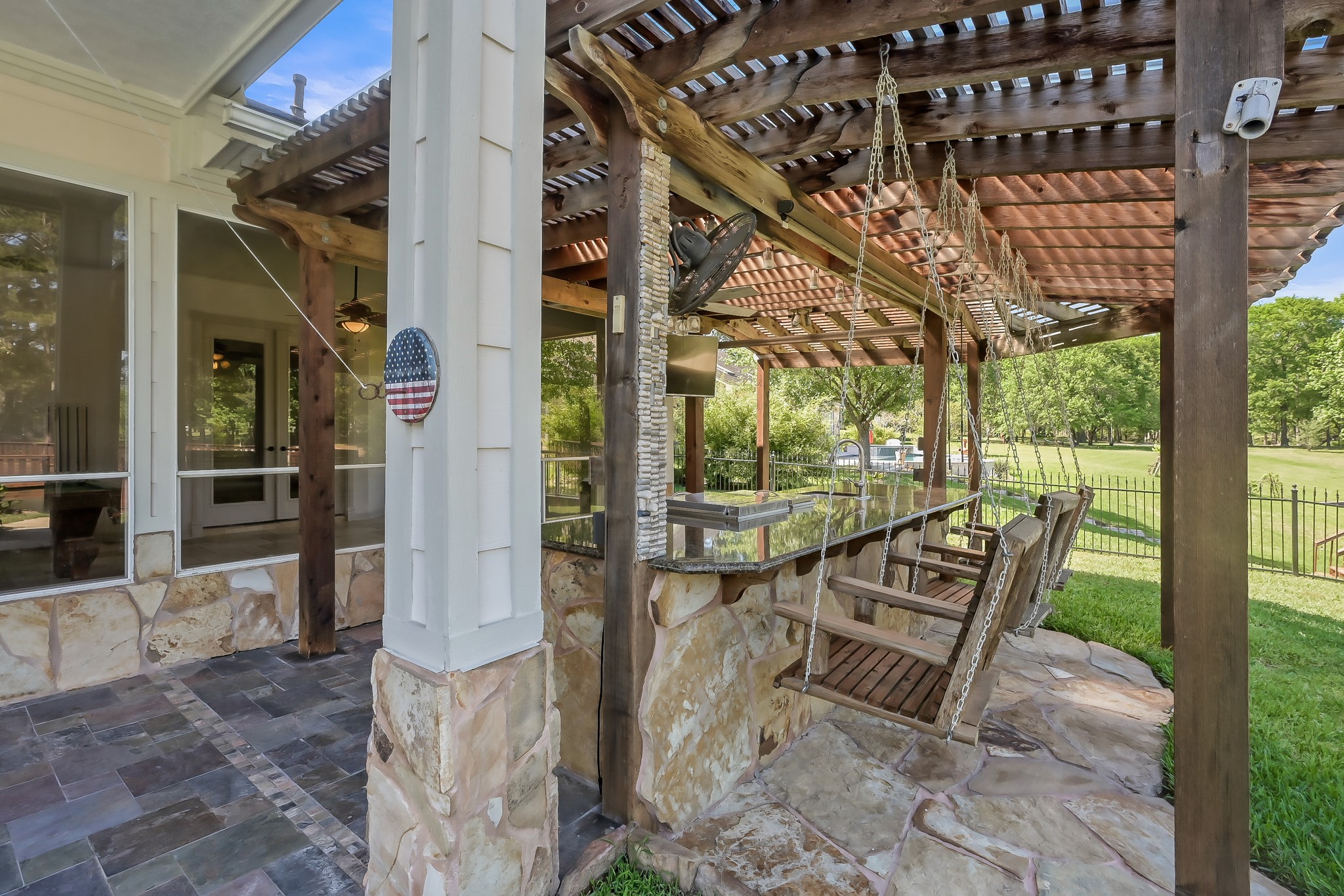 Swing seating along the Outdoor Kitchen Bar