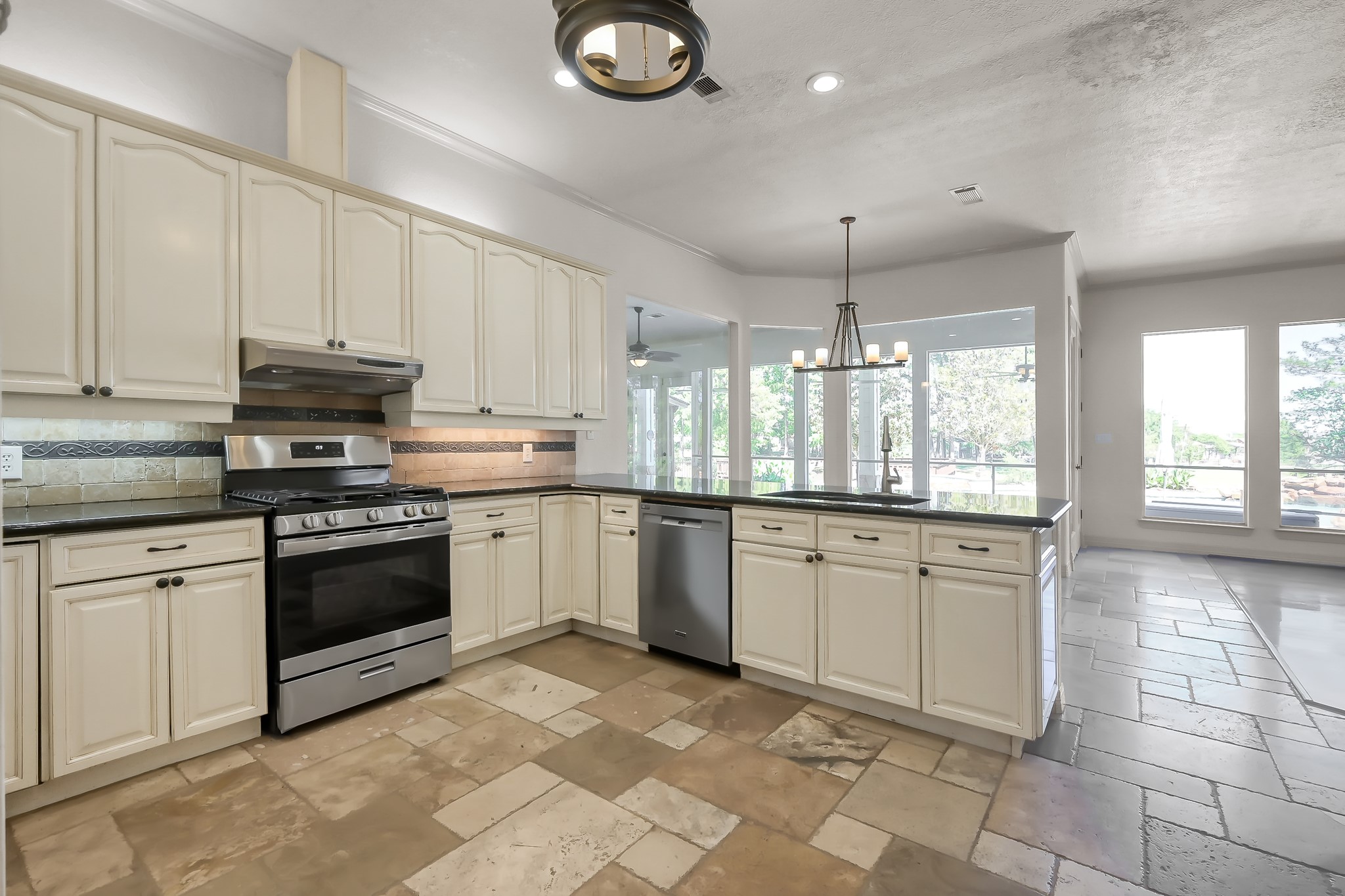 Kitchen has Over and Under Cabinet Lighting, Stainless Steel Appliances and Beautiful tile Flooring