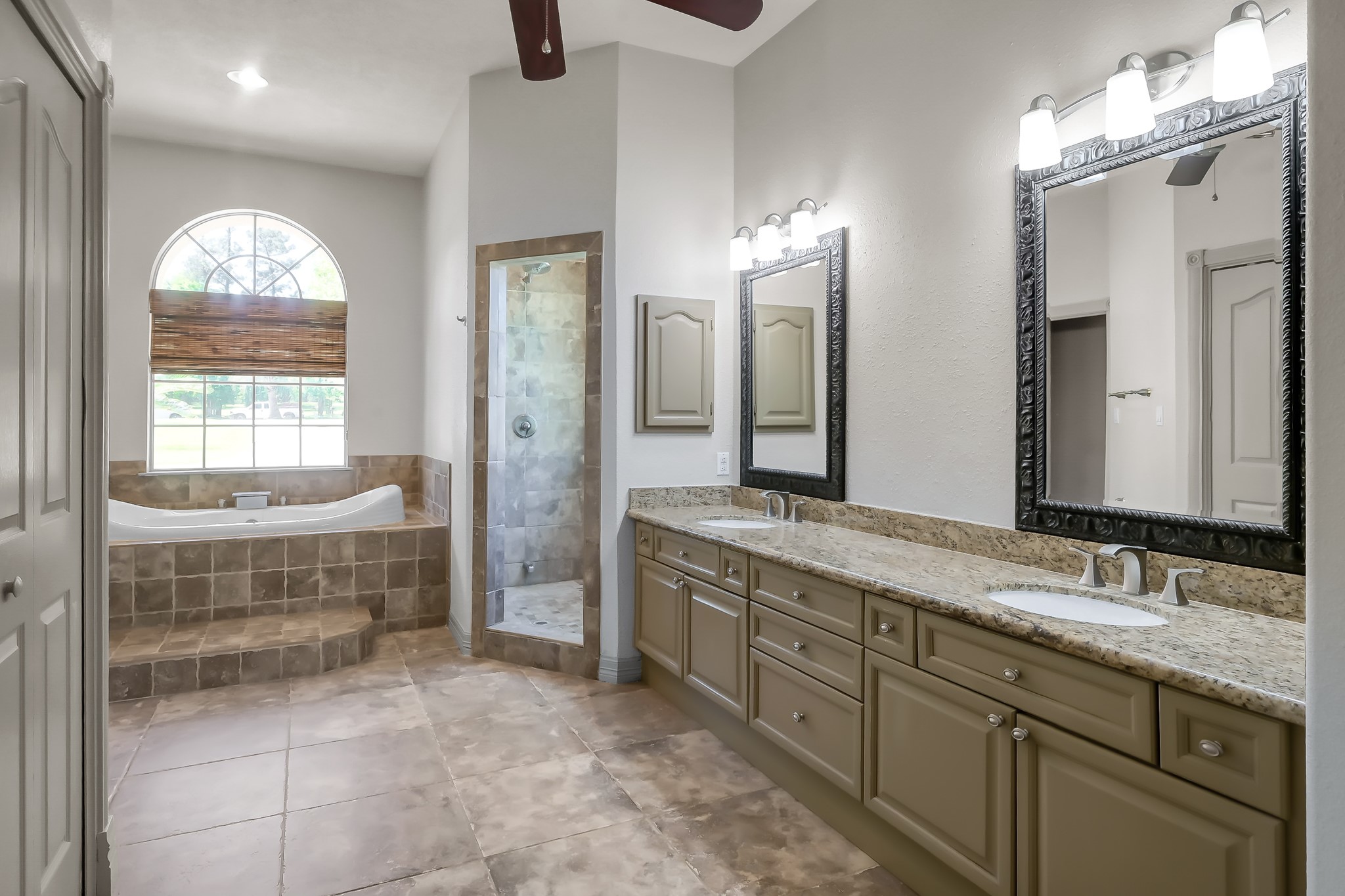 Primary Bathroom with lots of Beautiful Cabinetry and Granite Countertops
