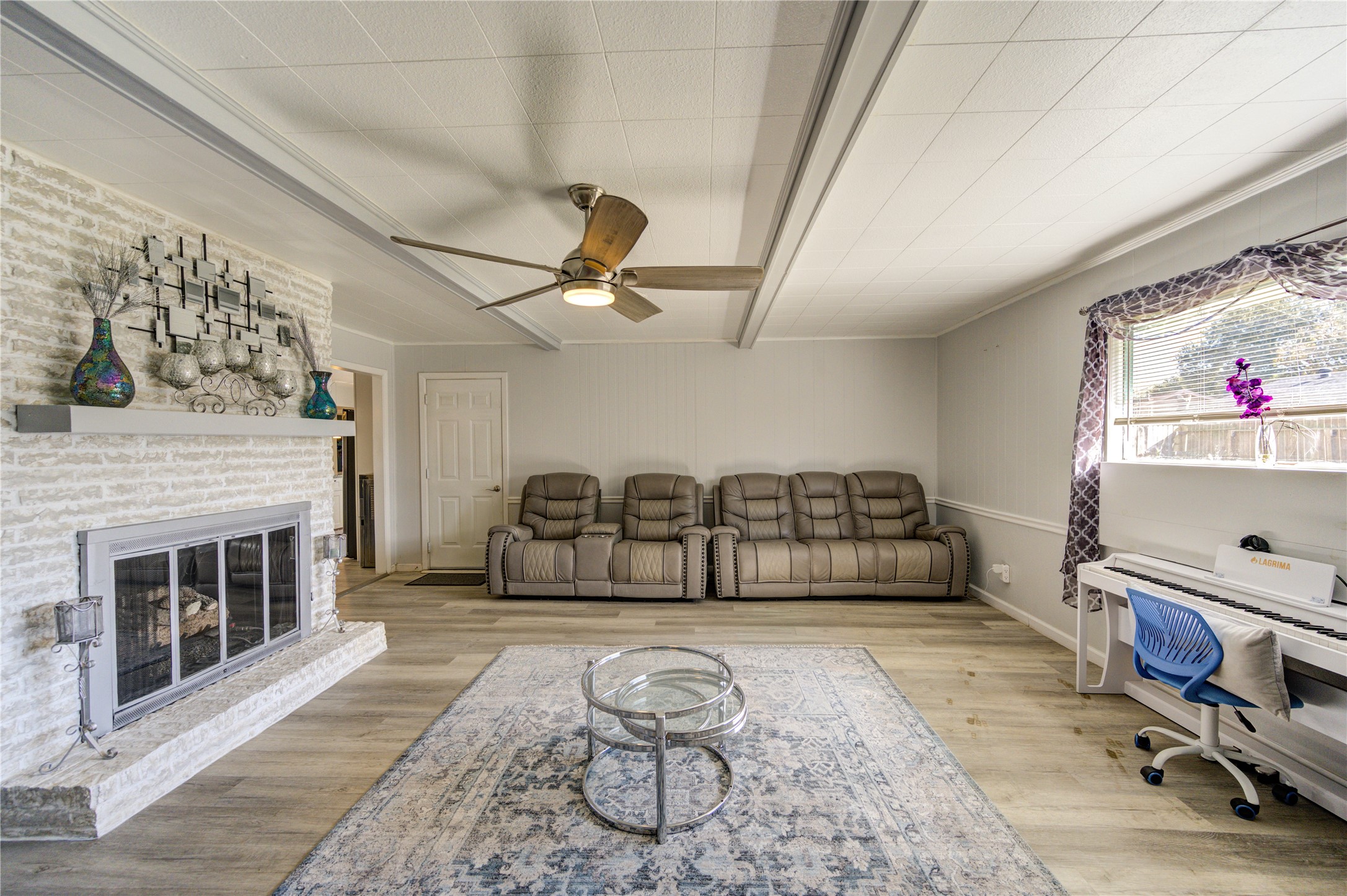 Another view of the den. The room's neutral tones create a warm and welcoming atmosphere, ideal for relaxation or entertaining.