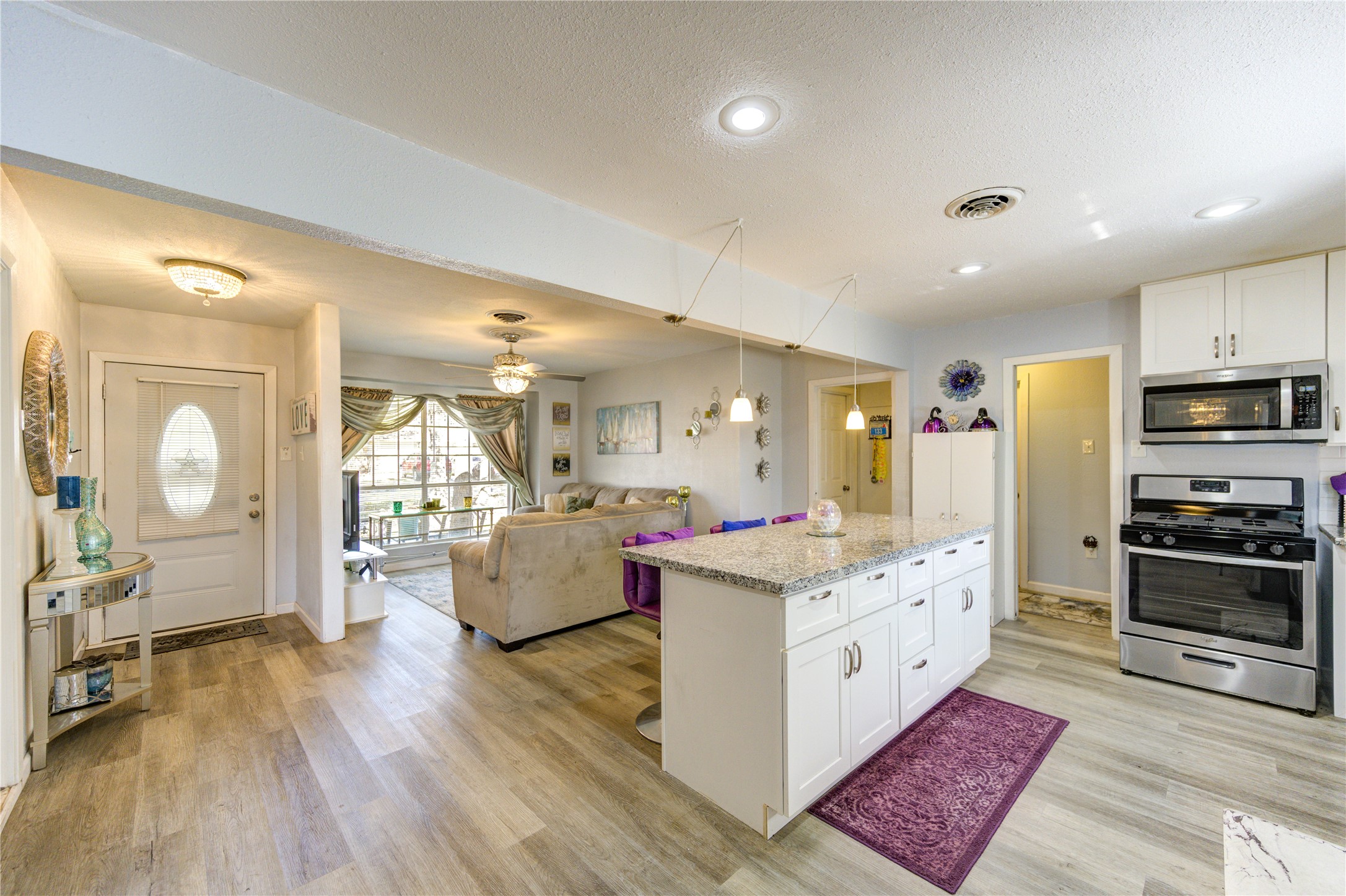 Adjacent to the kitchen, the living area is cozy with a large window for natural light.