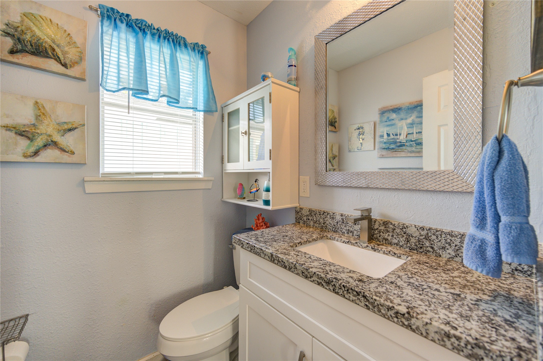 A view of the primary bedroom half bath.