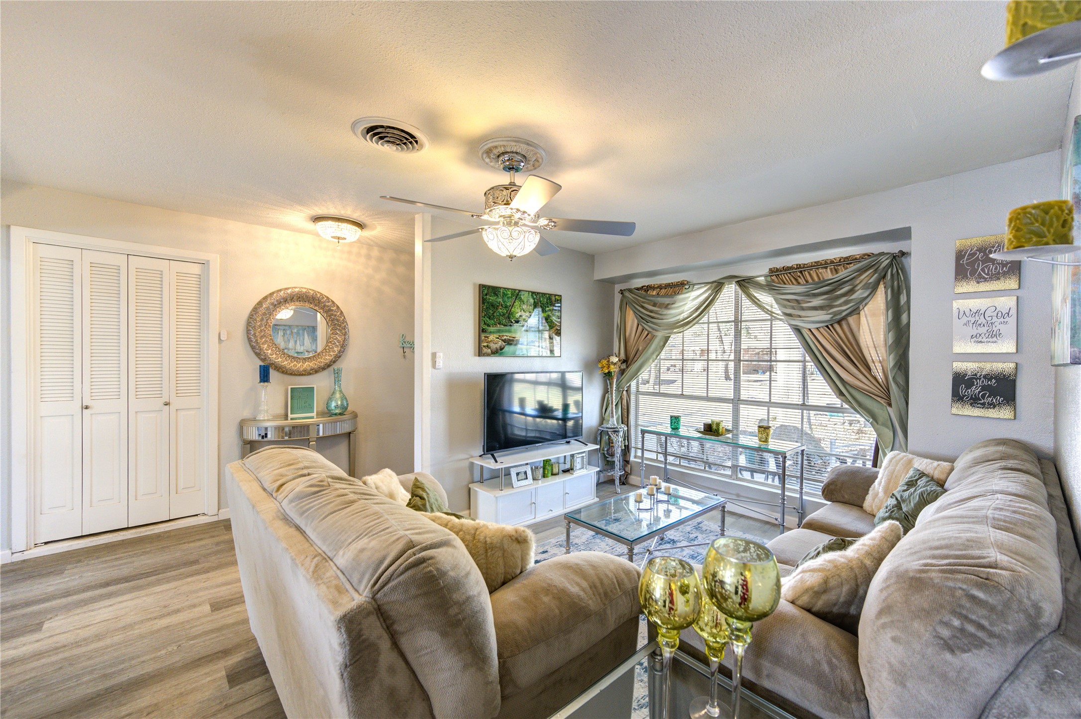 The living room features a large window and space to entertain or spend time with family while cooking dinner in the kitchen.