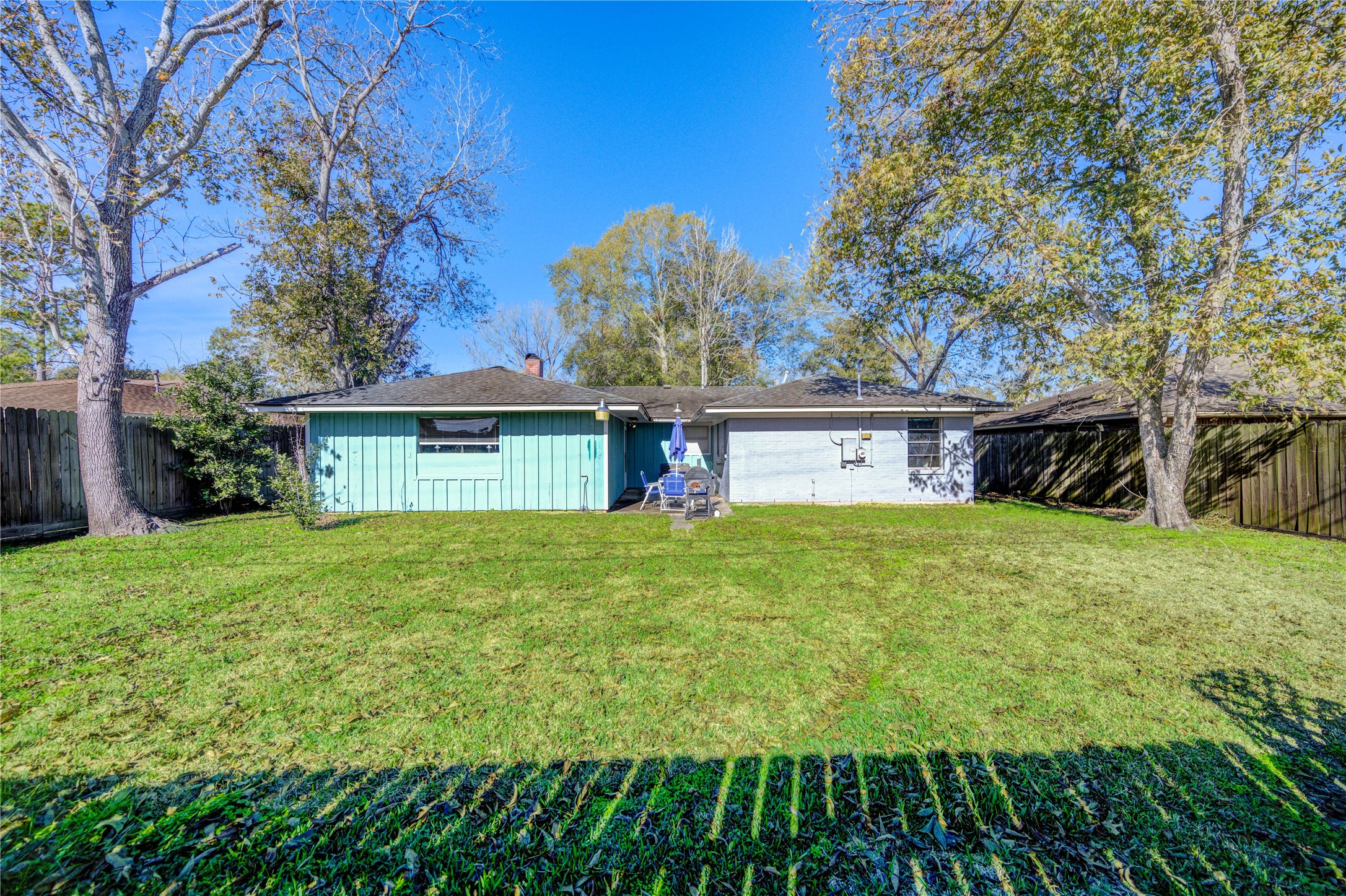 Ideal for outdoor seating or gatherings, this large backyard is ready for memory-making. Featuring mature pecan trees, and fully fenced yard.