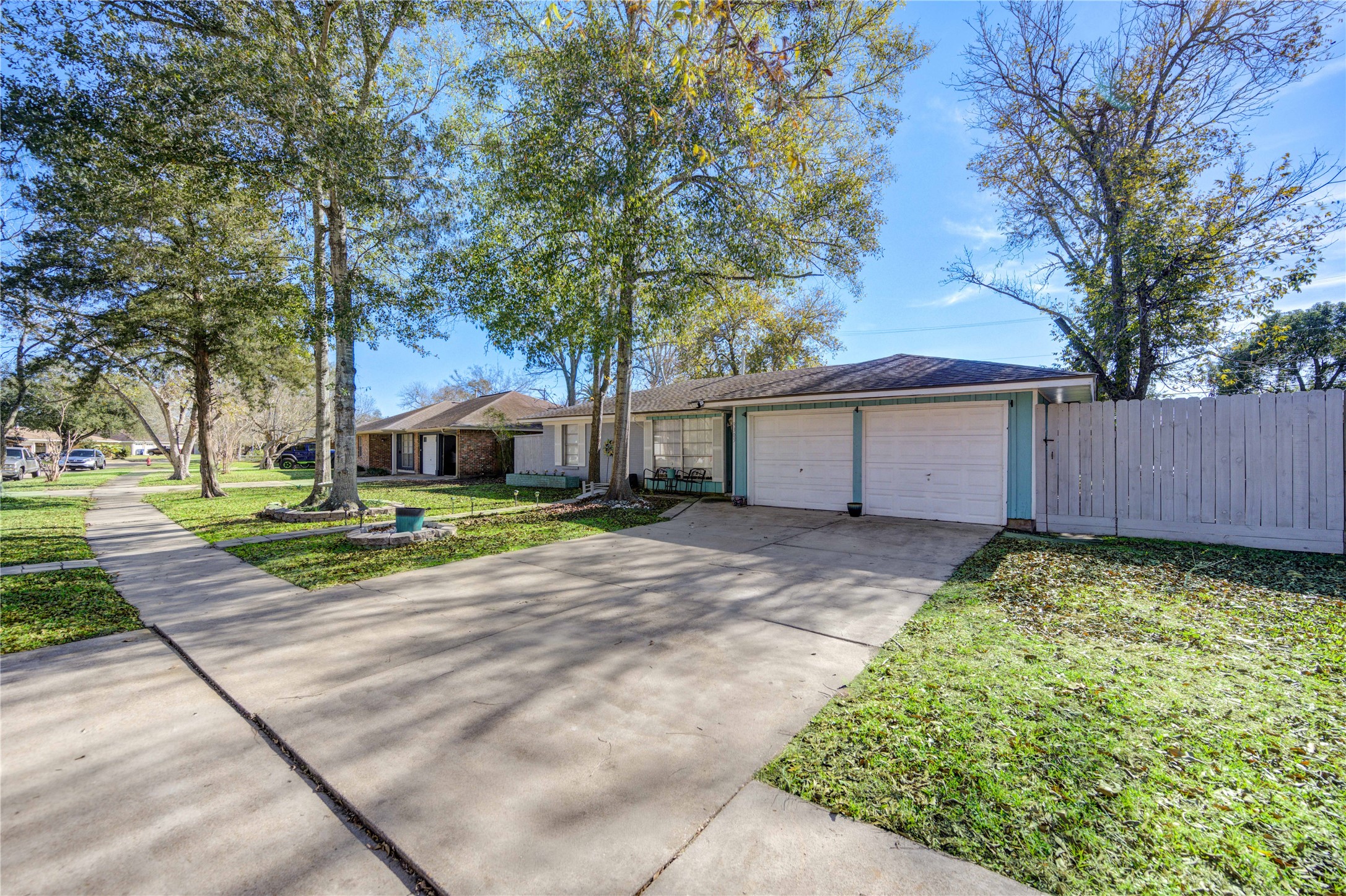 This home is surrounded by beautiful mature trees and a well-maintained lawn.