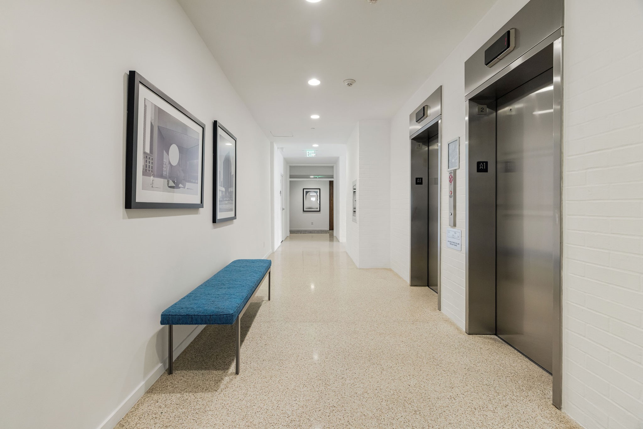 This 1965 building has been well maintained. You have a modern feel with sleek elevators, stylish artwork, and a comfortable bench, offering a welcoming entrance to the building.