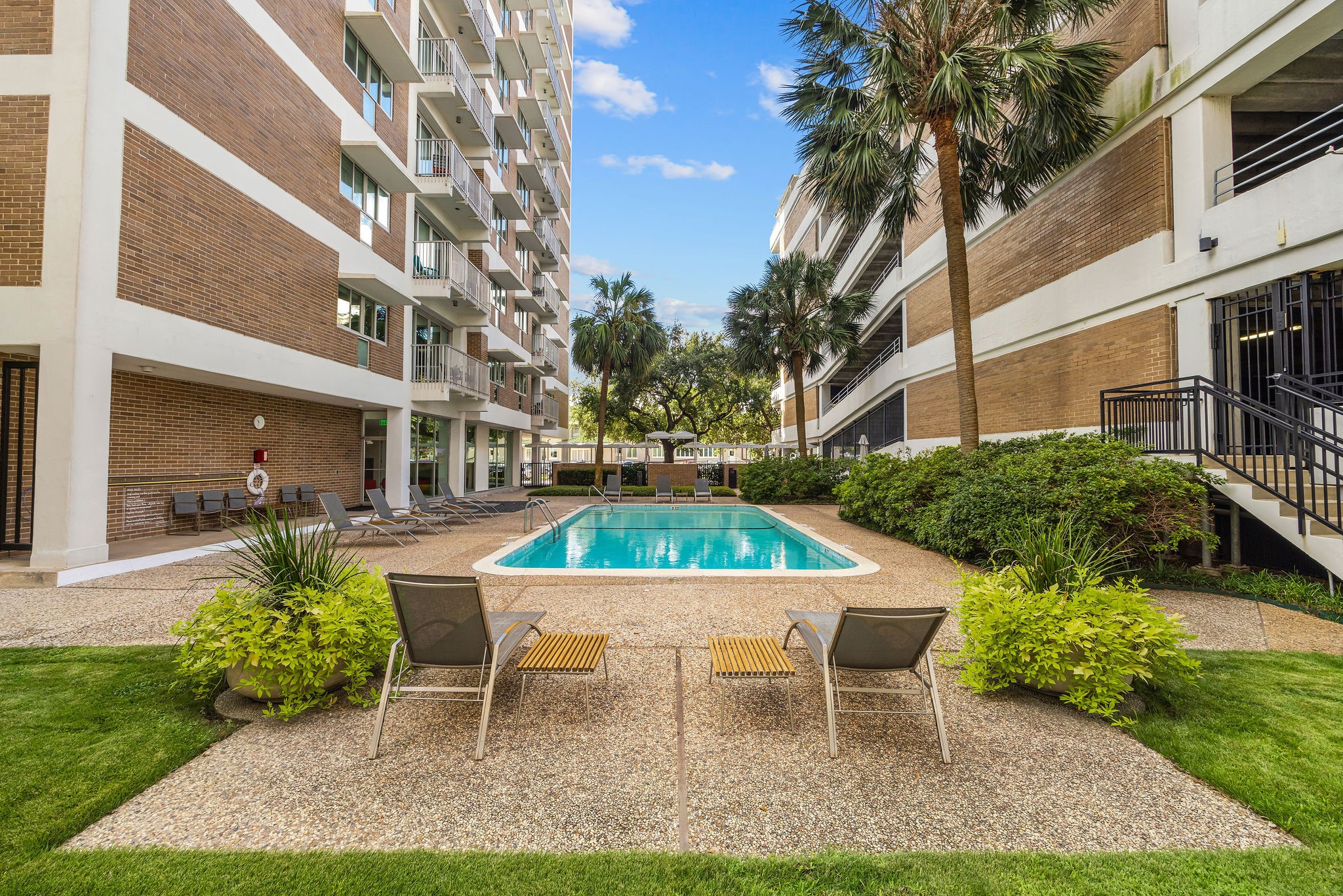 Enjoy a relaxing oasis with this inviting pool area, surrounded by lush greenery perfect for unwinding or socializing.