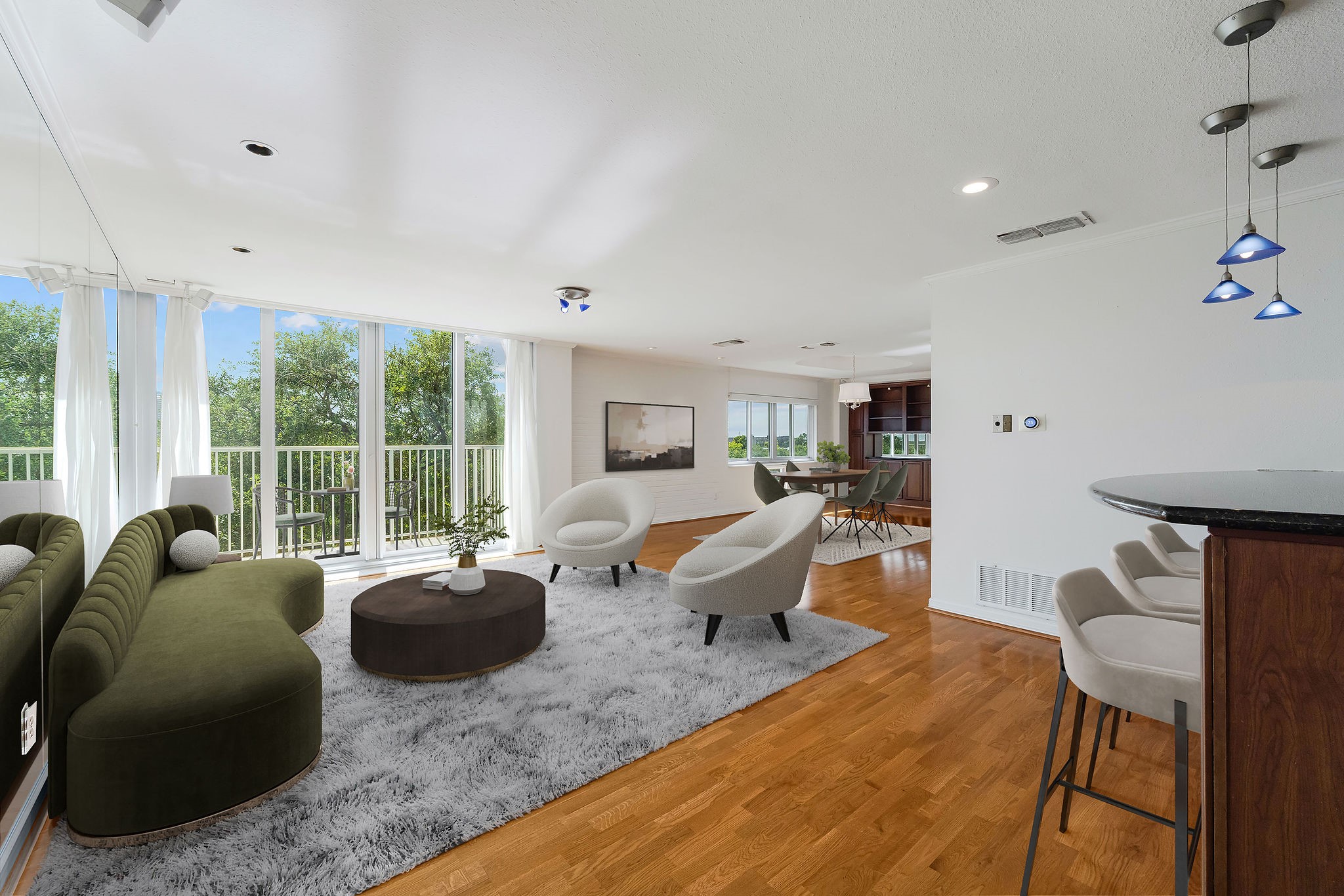 This virtually staged photo shows off a spacious open-concept living area with large windows offering abundant natural light and scenic views, featuring sleek wood flooring, modern furnishings, and stylish lighting.
