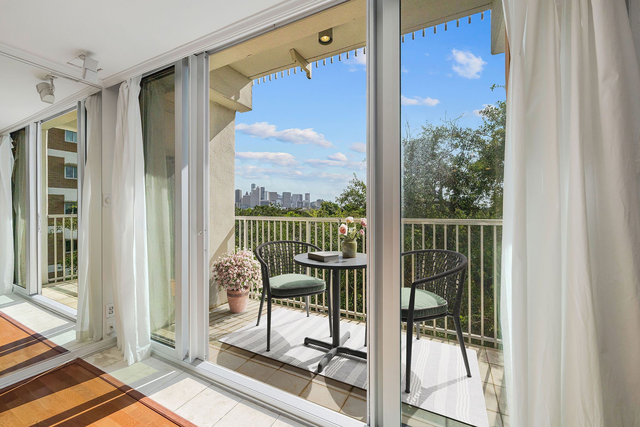Enjoy stunning city views from this bright, airy balcony, perfect for relaxing with a morning coffee.