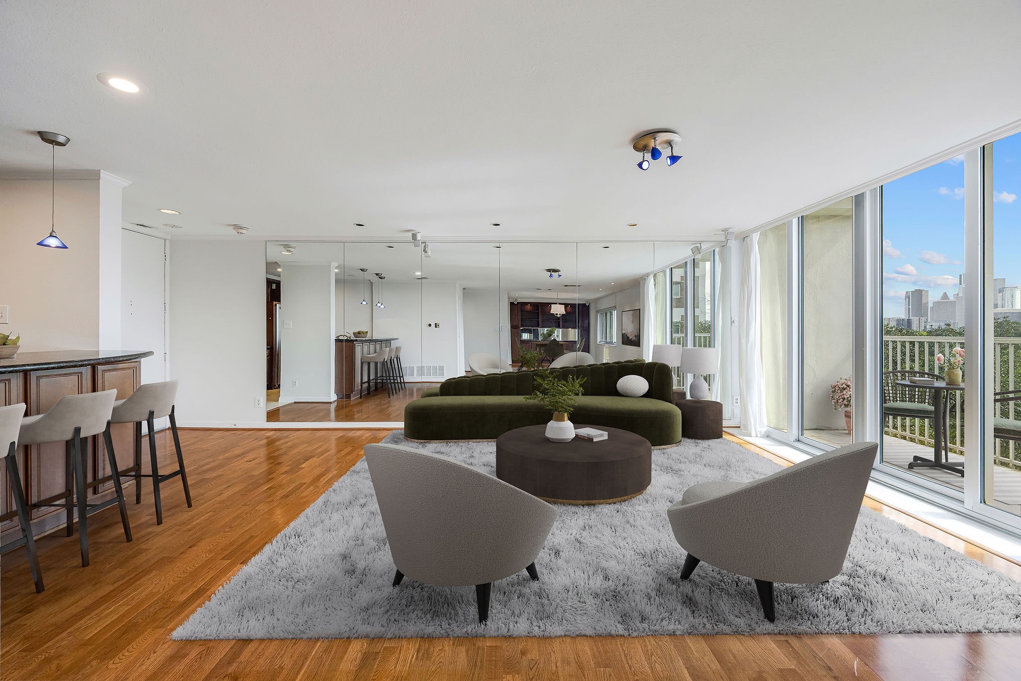 The virtual staged photo shows a spacious and modern living area featuring floor-to-ceiling windows with city views, sleek hardwood flooring, and a stylish open-concept design perfect for entertaining.