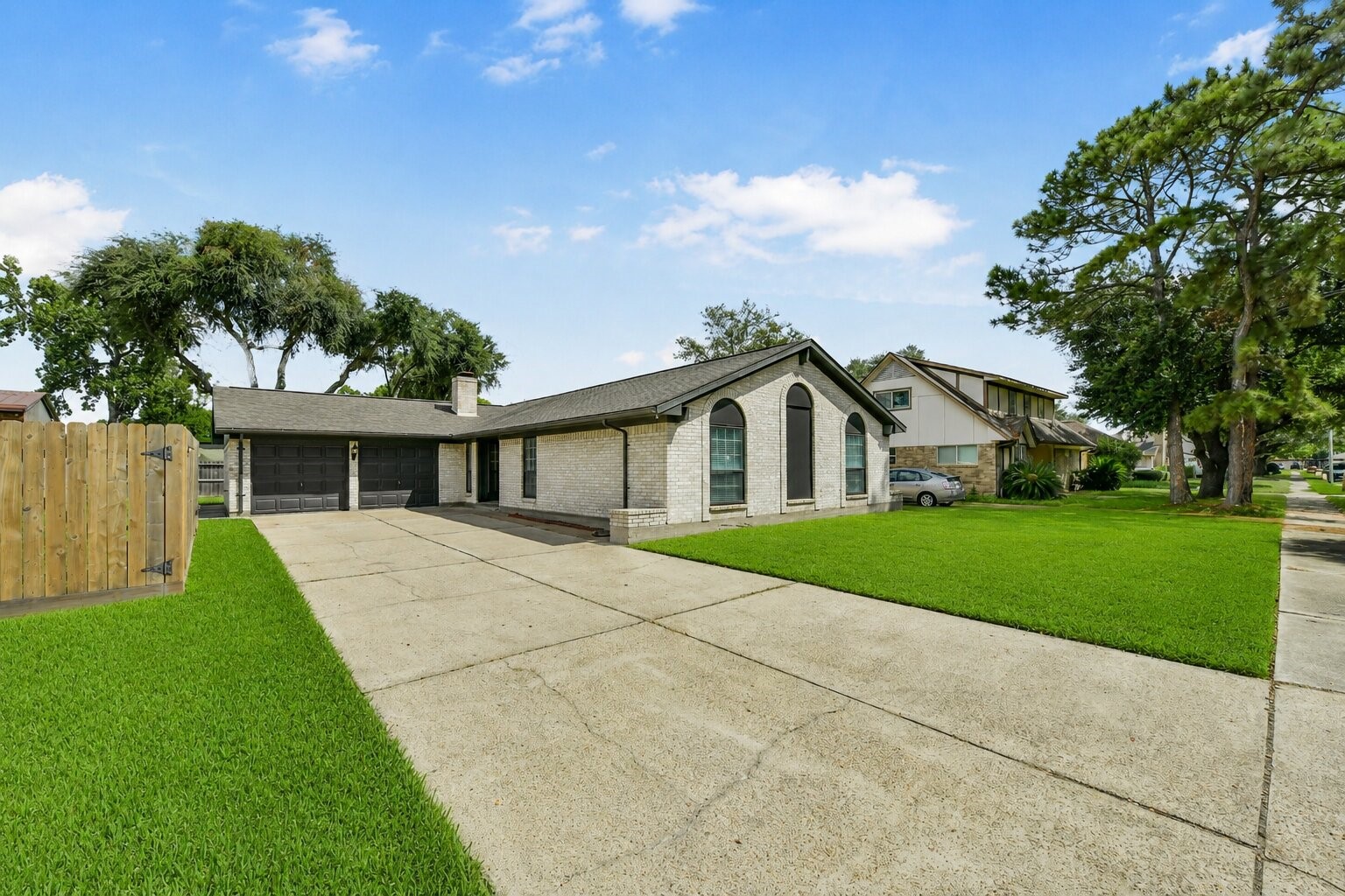 Single-story home with a spacious driveway, elegant arched windows, and a beautifully manicured lawn, nestled in a serene neighborhood. Single-story home with a spacious driveway, elegant arched windows, and a beautifully manicured lawn, nestled in a serene neighborhood.