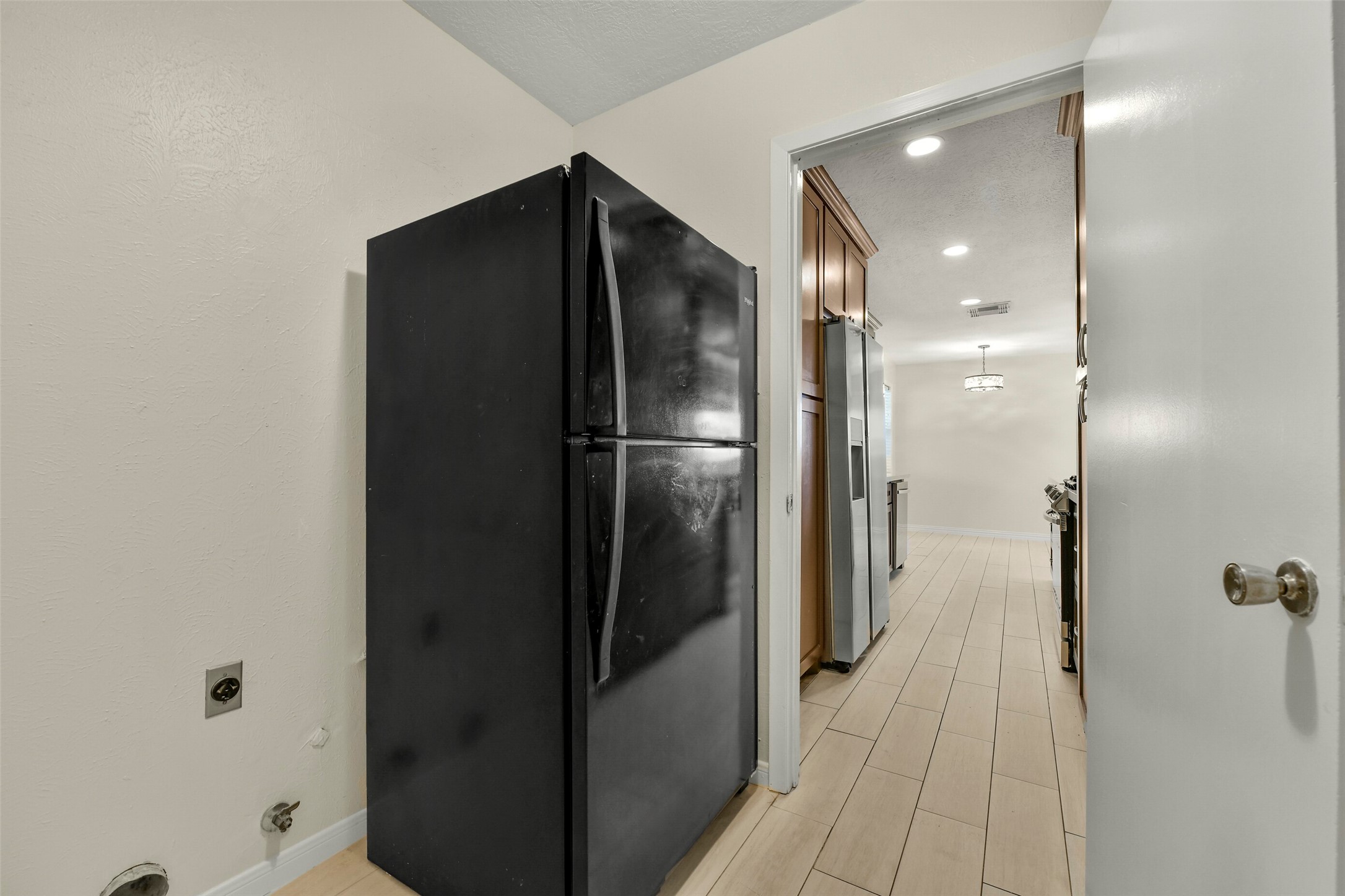 Utility area with convenient access to a modern kitchen.