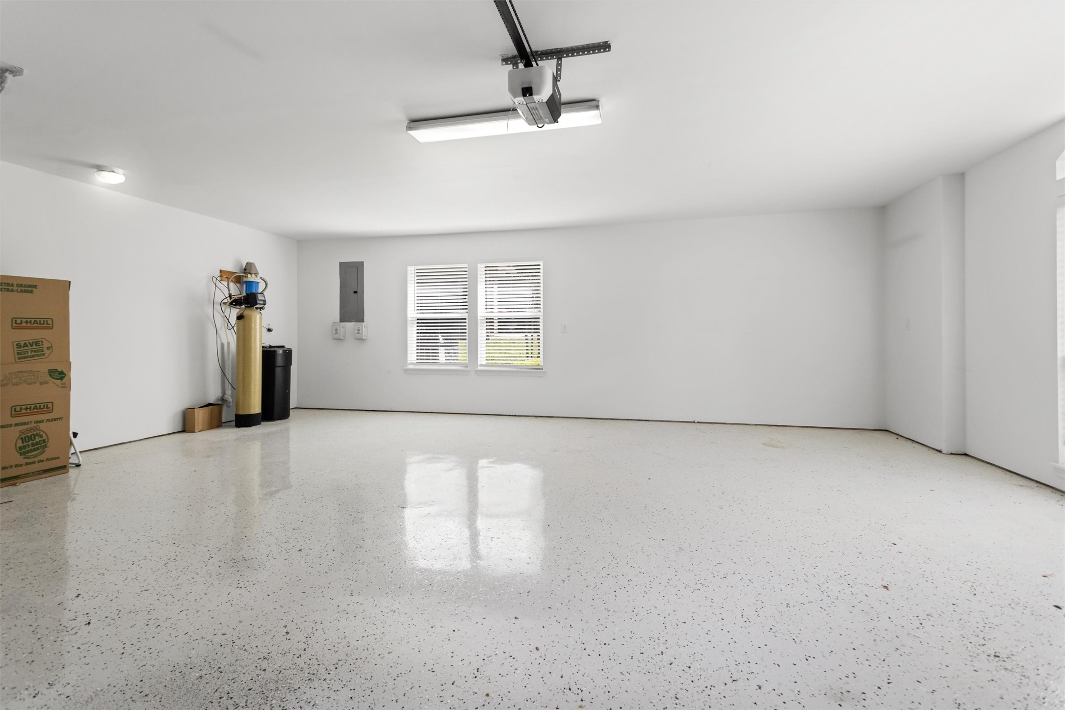 Check out this huge two-car garage! Its got fresh epoxied floors, new insulated doors, and a new opener, so theres plenty of room for your cars and gear. Plus, youve got a water softener and the sprinkler system controls all tucked away in here.