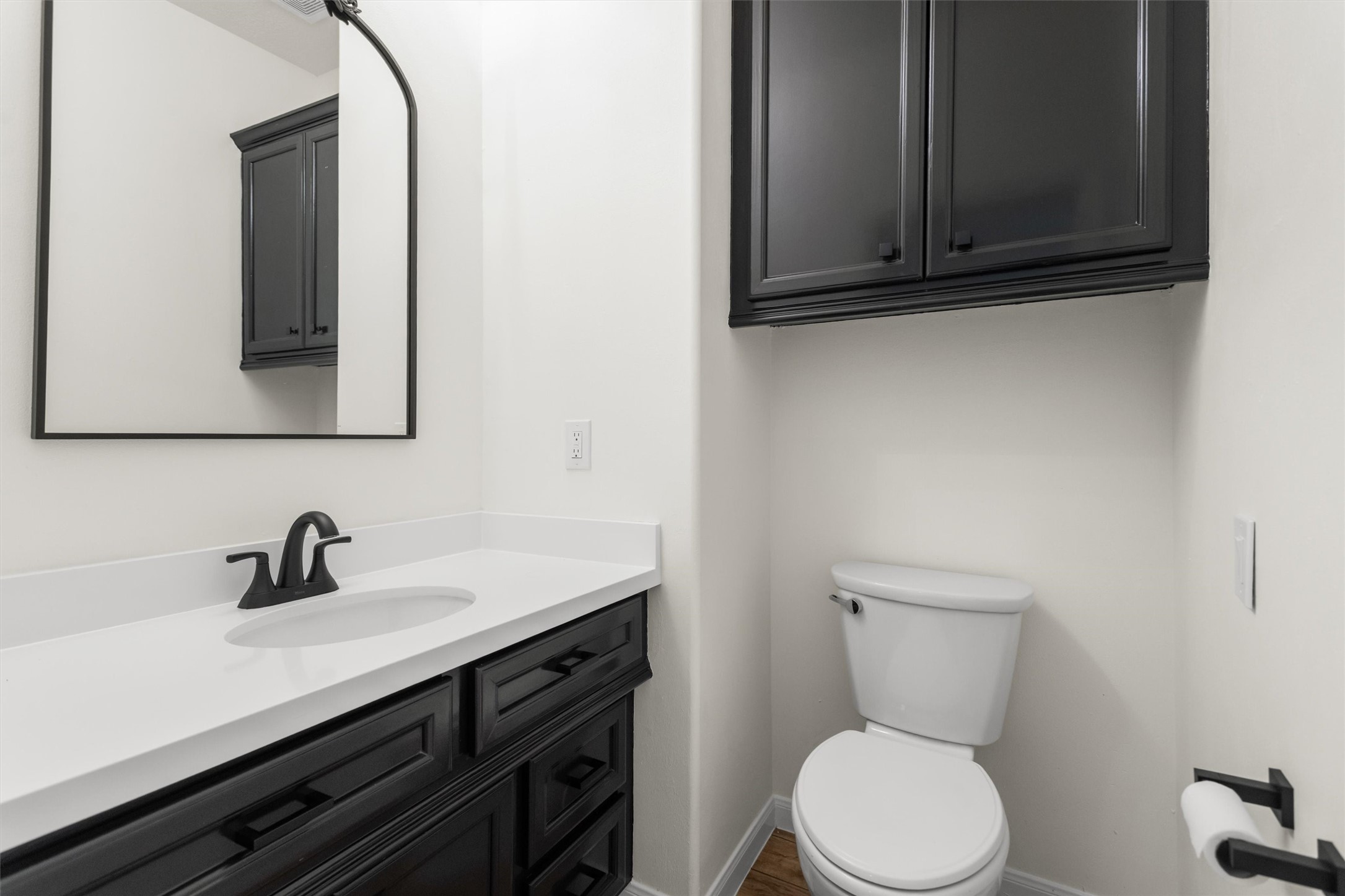 The recently updated half bathroom provides a convenient space for guests.