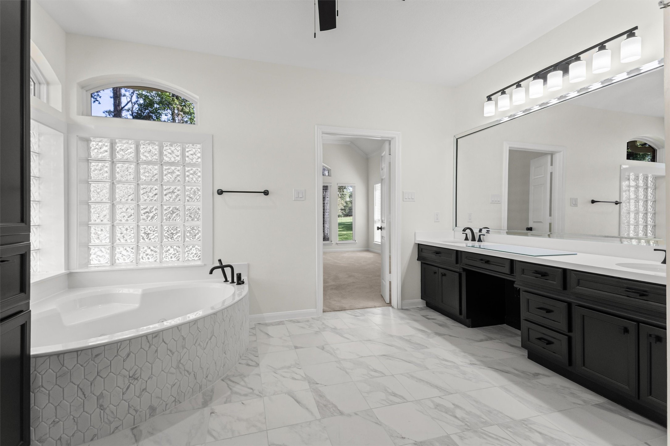 The double sinks and vanity area provide ample space to accommodate busy morning routines.