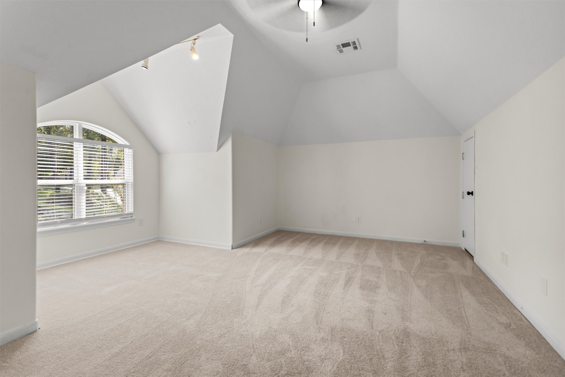 This spacious room located above the garage is perfect for use as a game room, media room, or bunk room. It includes two convenient access points to the attic, providing easy entry to storage areas and the HVAC units.