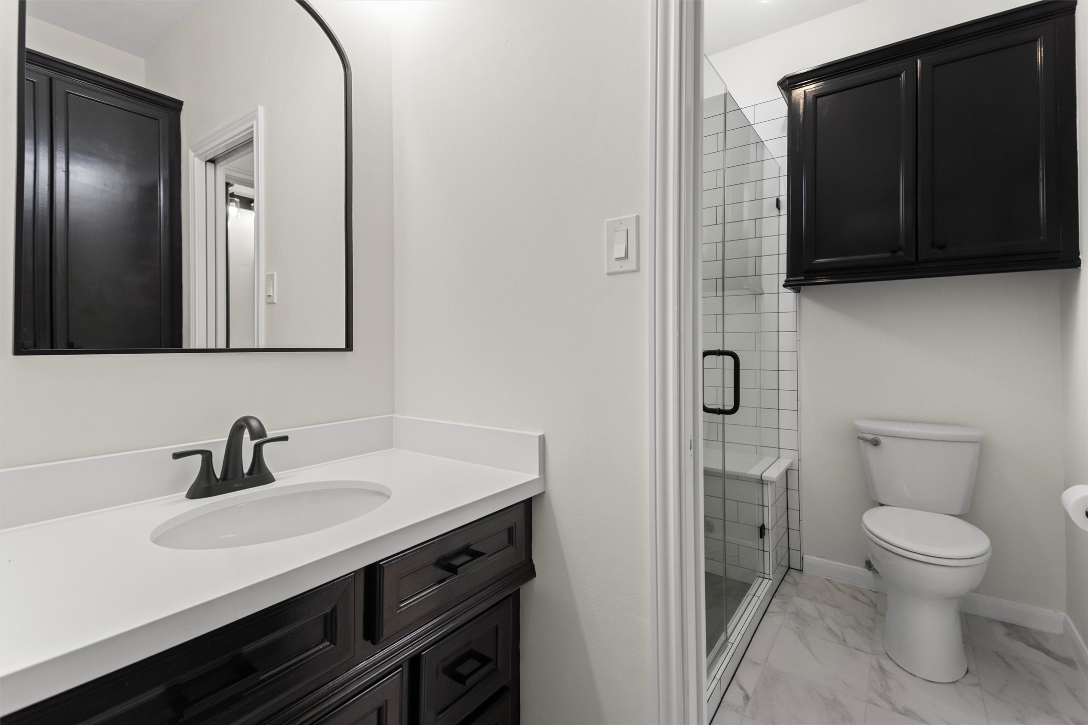 This recently updated Hollywood bathroom, shared by the two secondary bedrooms, features separate vanities and a shower.