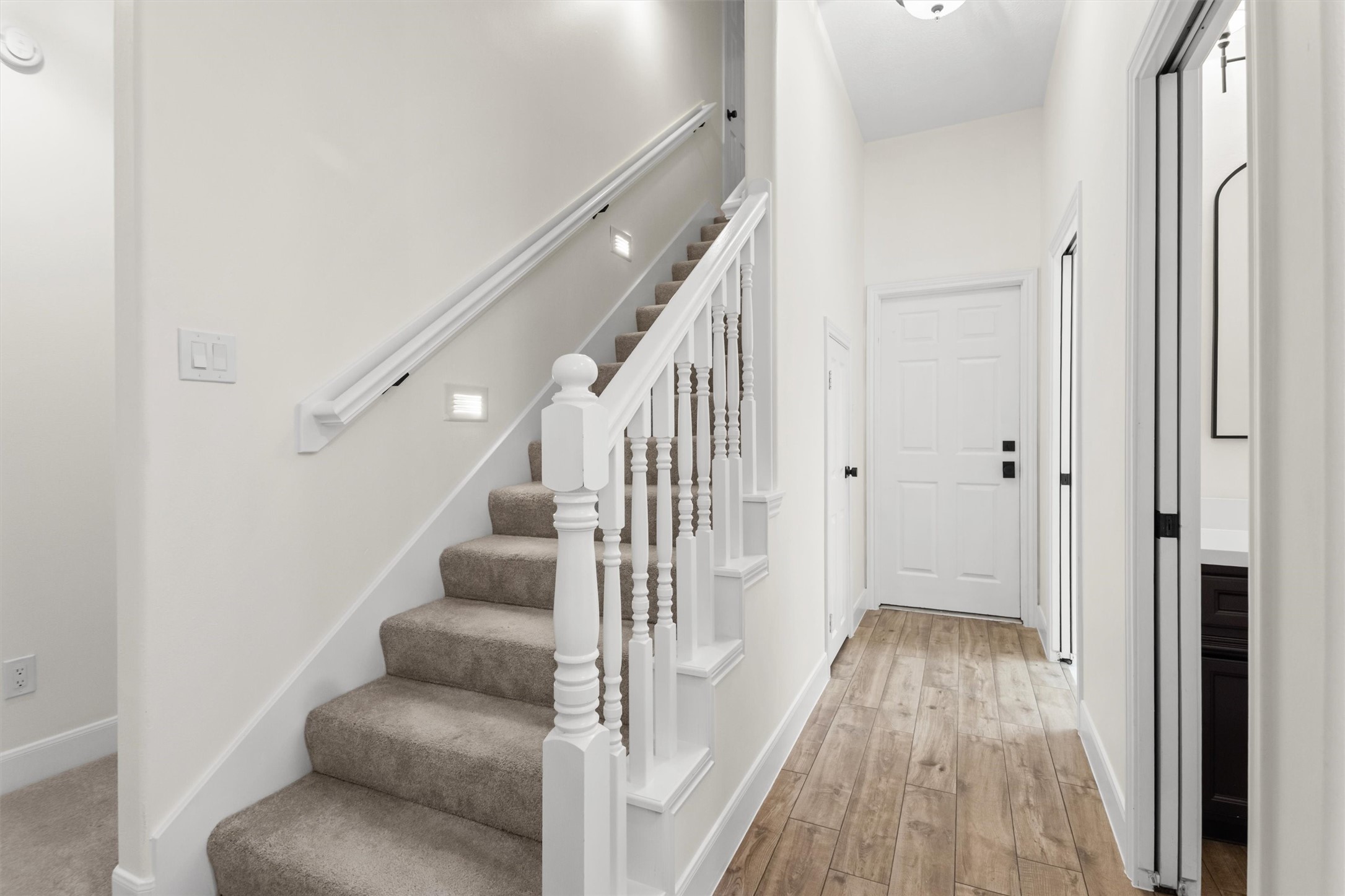 The first floor serves as the main living area. The upstairs features a large 1.5-story flex space above the garage, perfect for a game room or bunkroom, with convenient access to the attic and HVAC systems. The downstairs hallway provides easy access to a half-bath, a spacious laundry room, a utility closet, and a two-car garage.