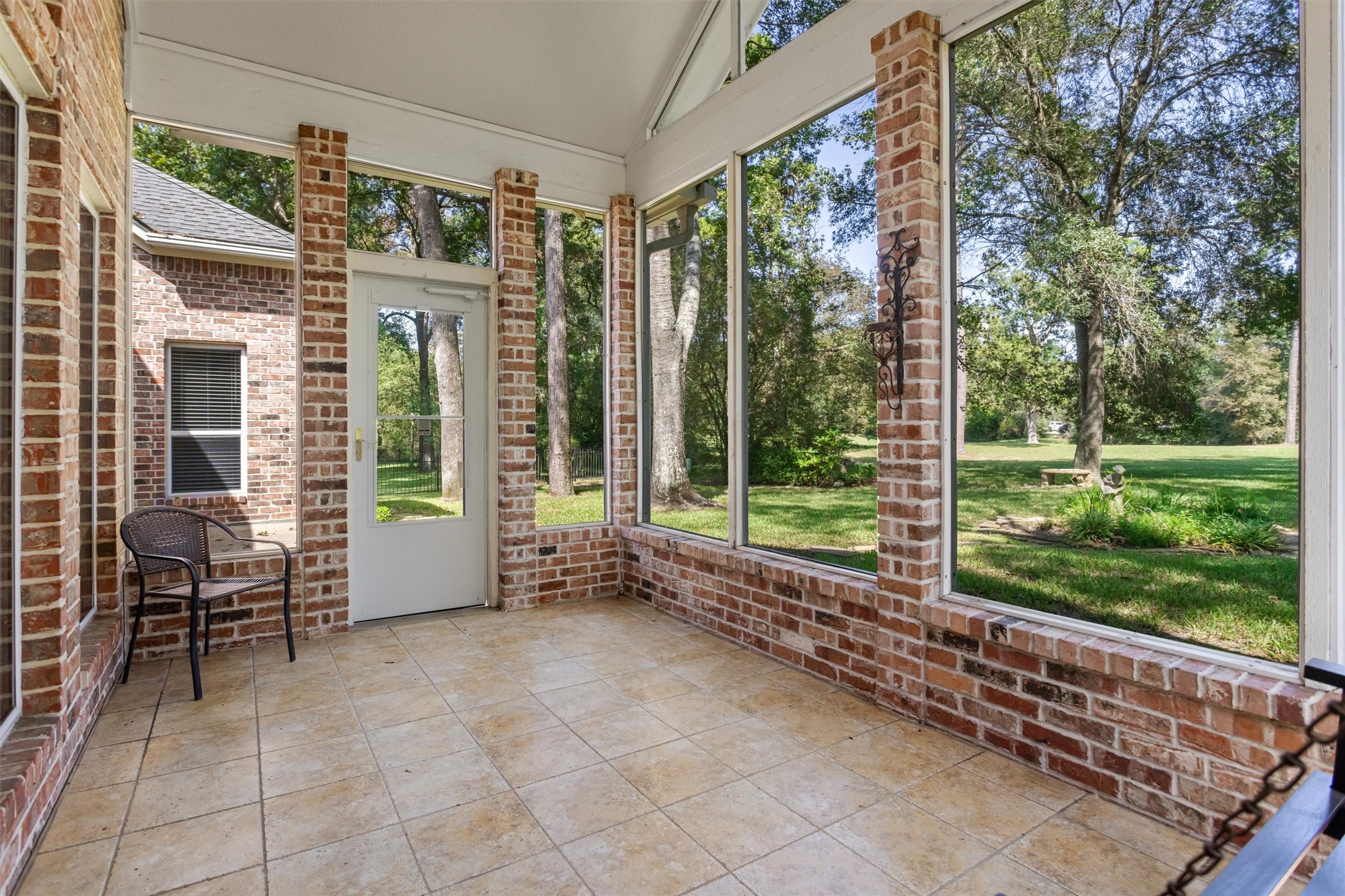 The screened in sunroom allows you to enjoy the outdoors year round in Conroe. With no back neighbors, you can enjoy the peaceful view of the greenspace while sipping your coffee. The screened in sunroom allows you to enjoy the outdoors year round in Conroe. With no back neighbors, you can enjoy the peaceful view of the greenspace while sipping your coffee.
