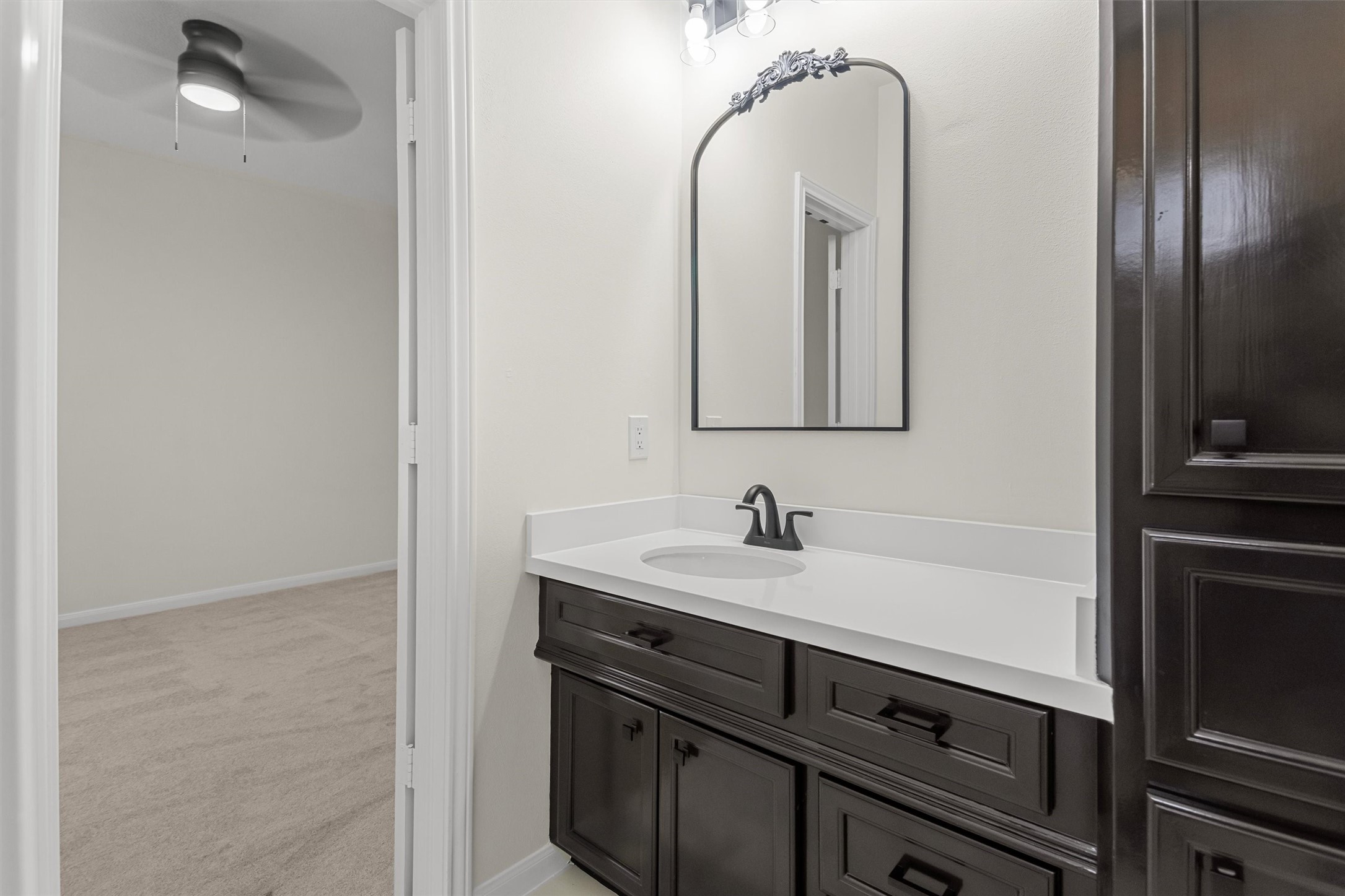 This vanity area in the Hollywood bath highlights the spacious countertop and elegant cabinetry, offering ample storage and prep space.