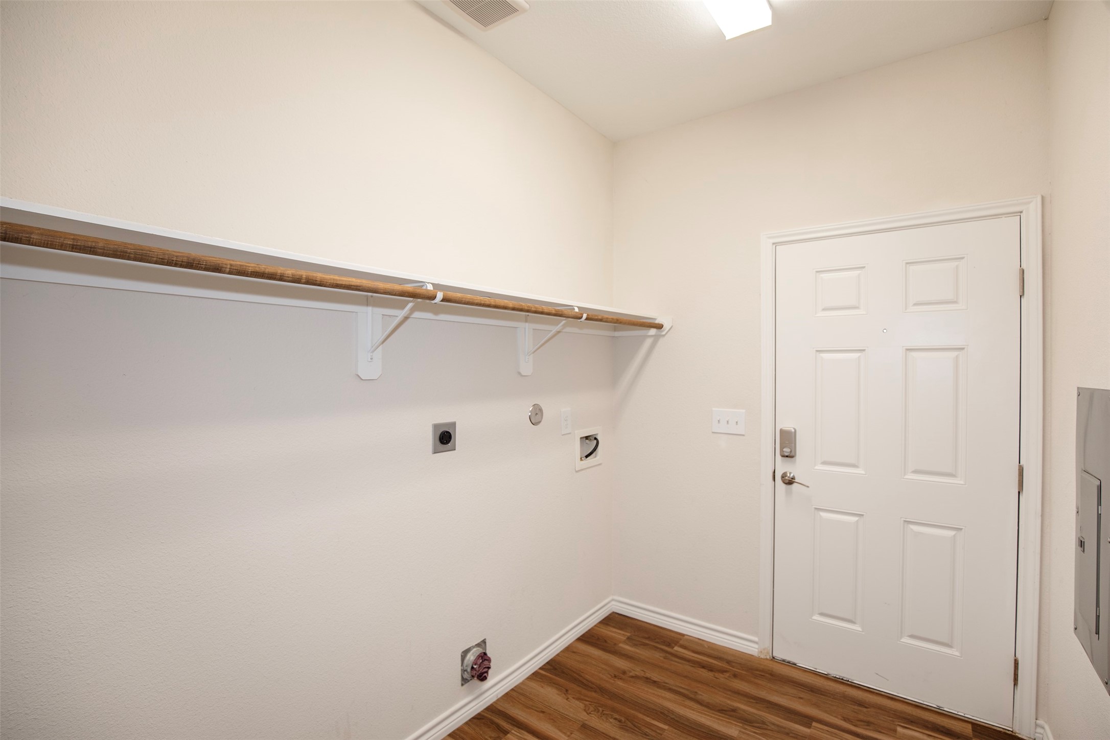 The utility room is located just inside the side entrance.