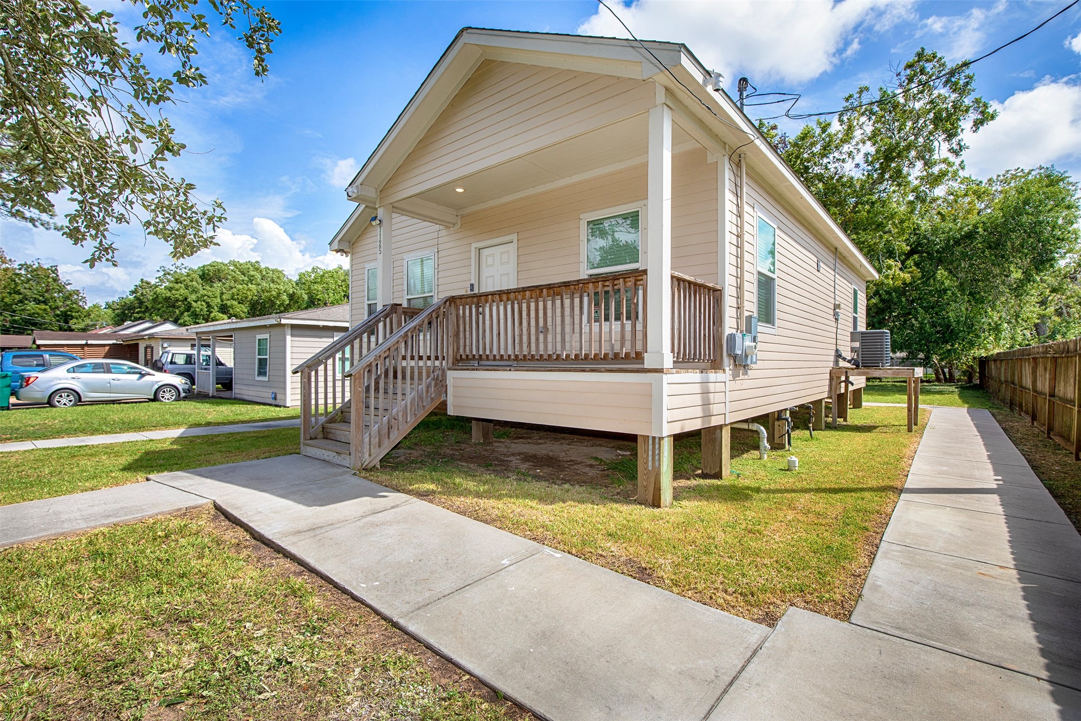 The sidewalk wraps around the home to a wheelchair accessible ramp.