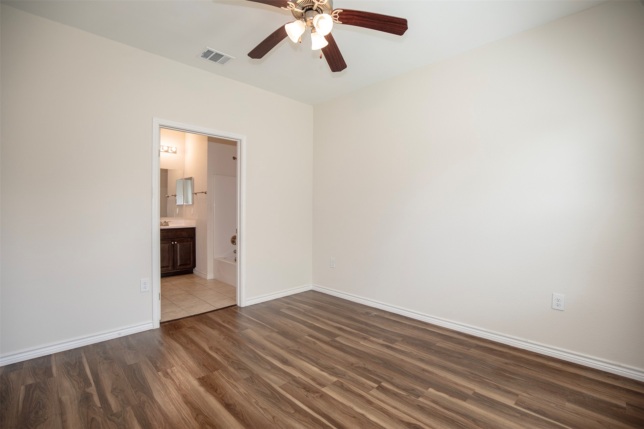 Natural light fills the room in the primary suite.