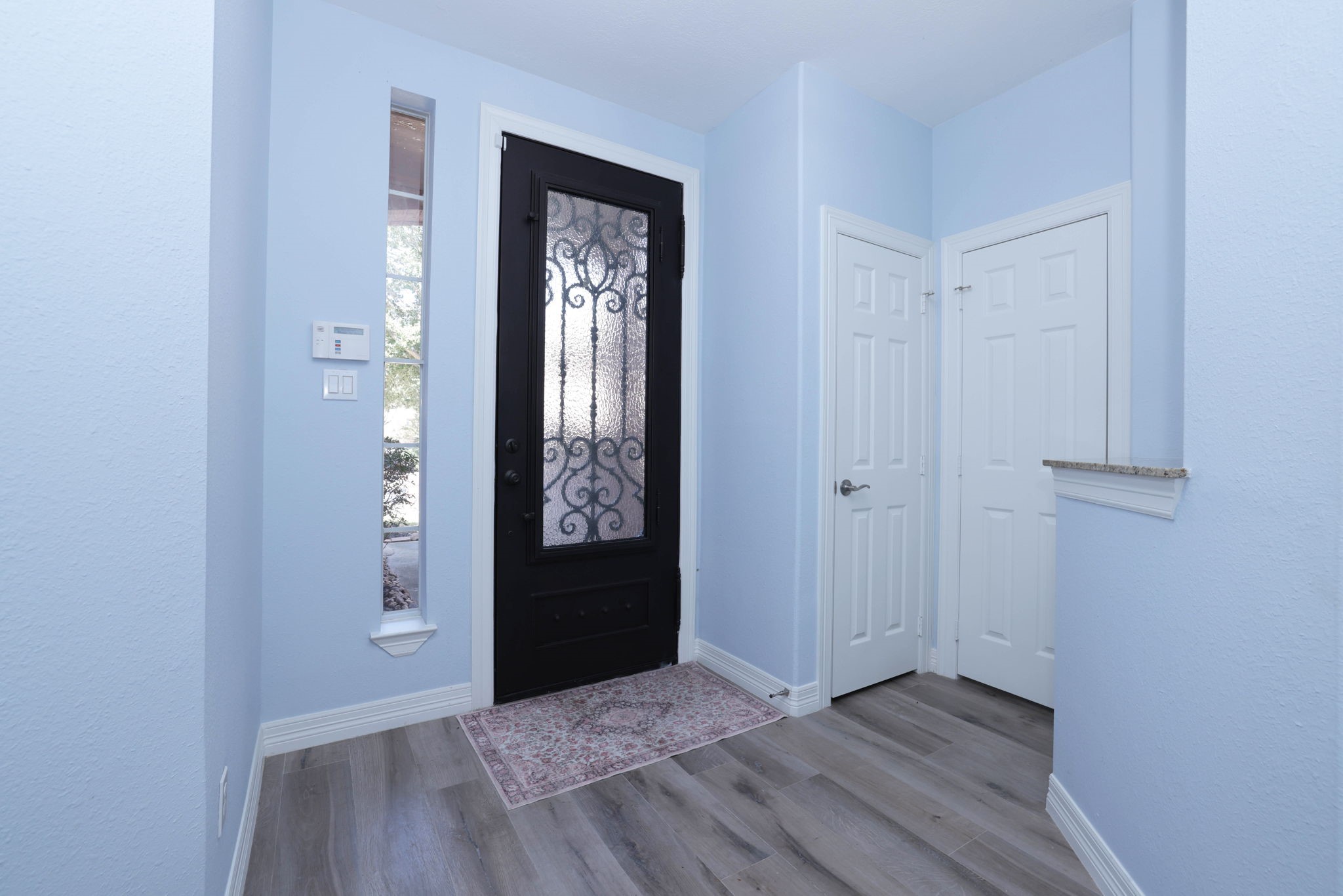 The entry is light and bright with the glass door and side light.